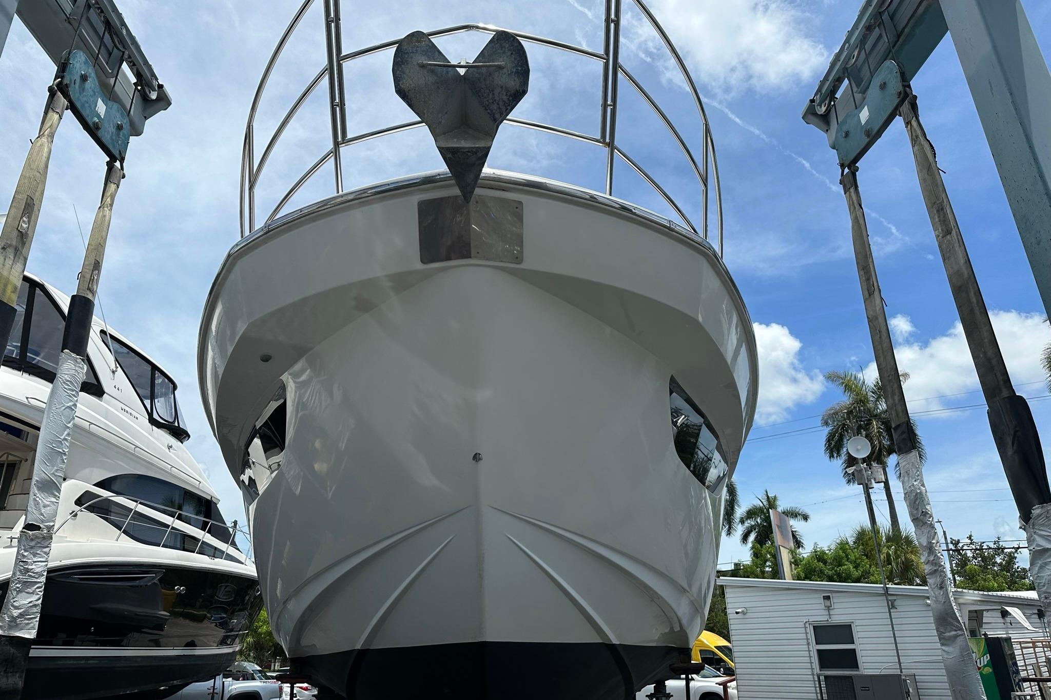 Azimut Fly 53 yacht from 2013 on a lift, under a clear blue sky.
