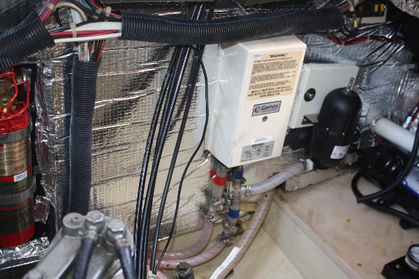 The engine room of a 1985 Nordic Tug 26 shows wiring and insulation.