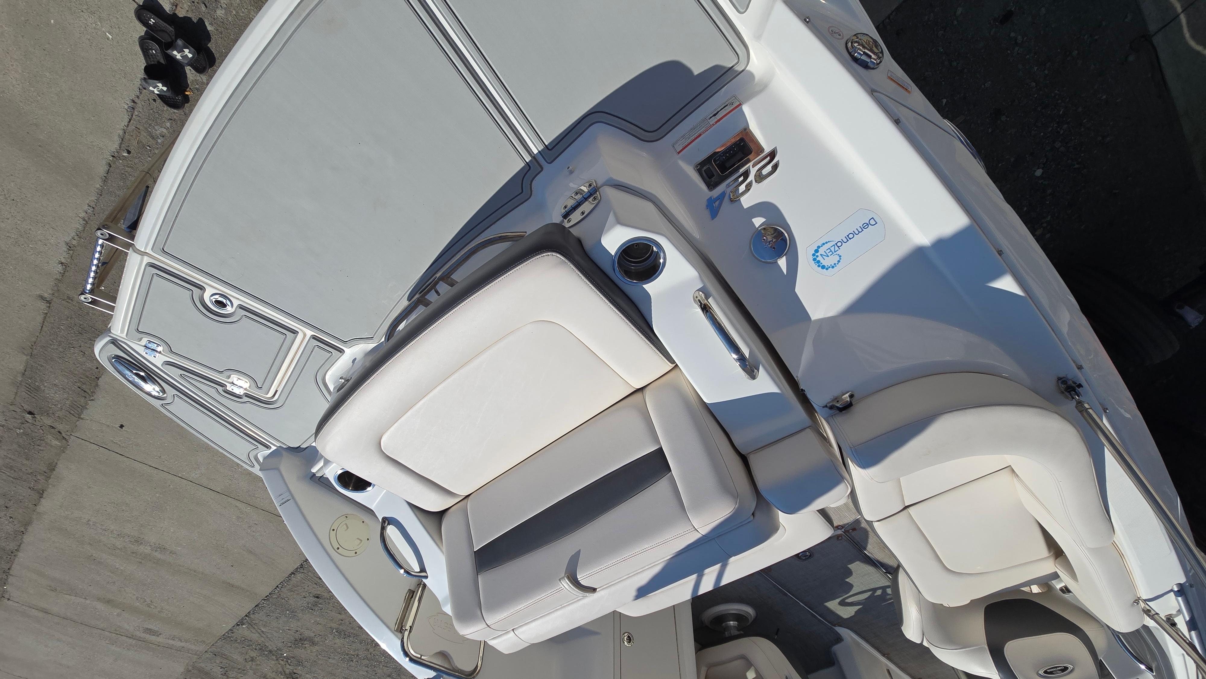 2018 Chaparral 224 Sunesta boat interior with white seating and control panel.