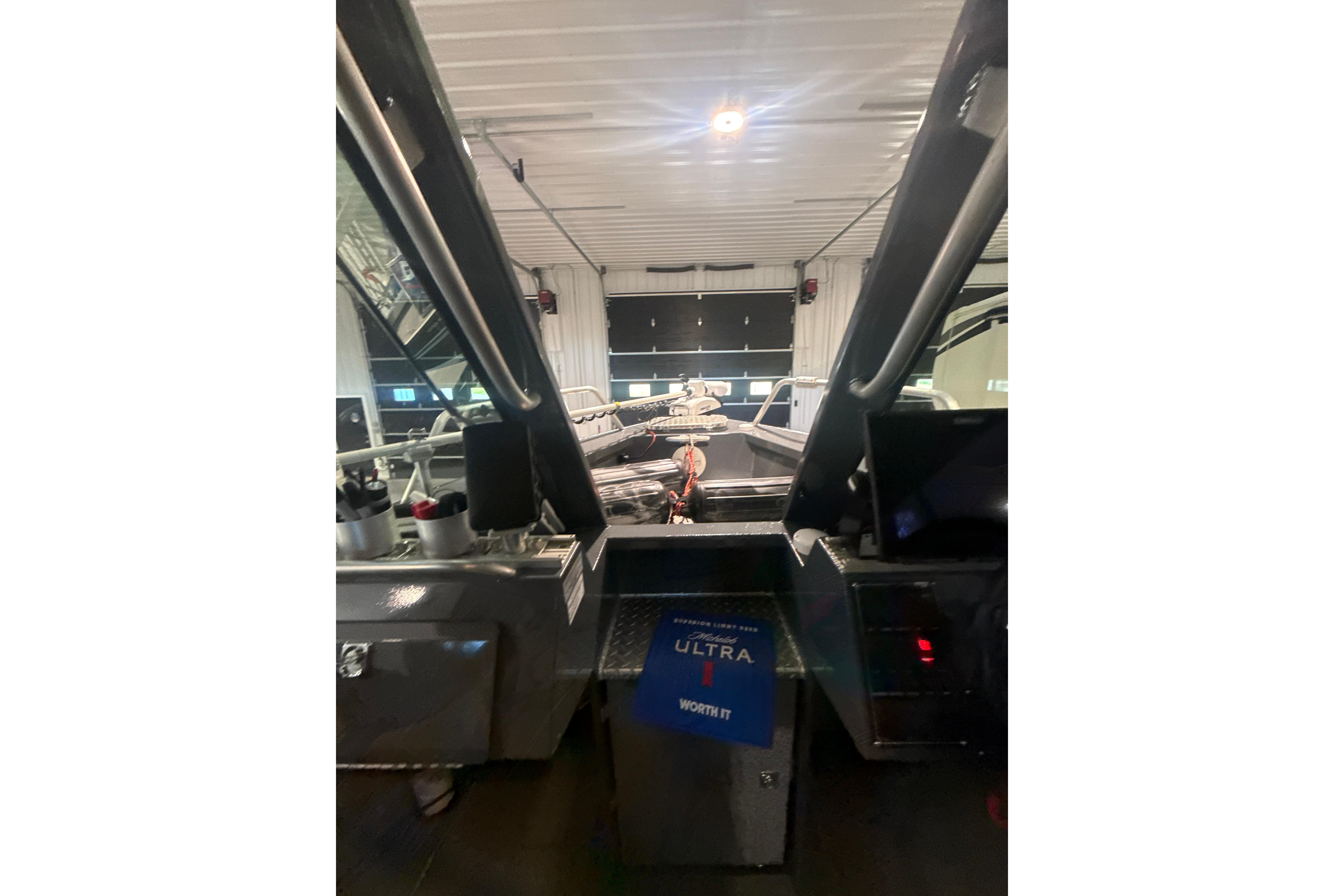 Interior view of 2022 Hewescraft 270 Alaskan Hardtop in a garage setting.