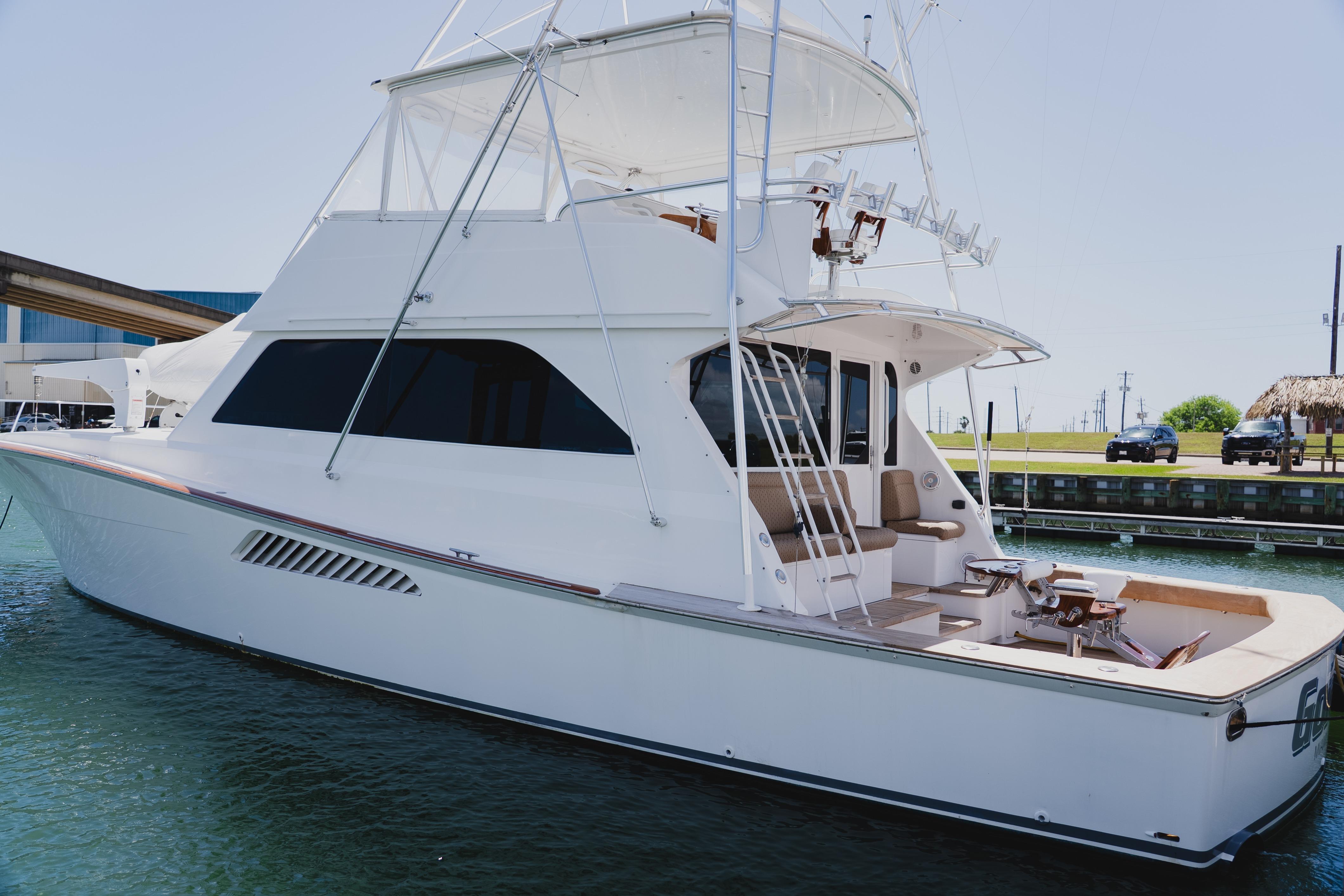 1999 Viking 58 Convertible yacht docked in marina, showcasing sleek design and spacious deck.