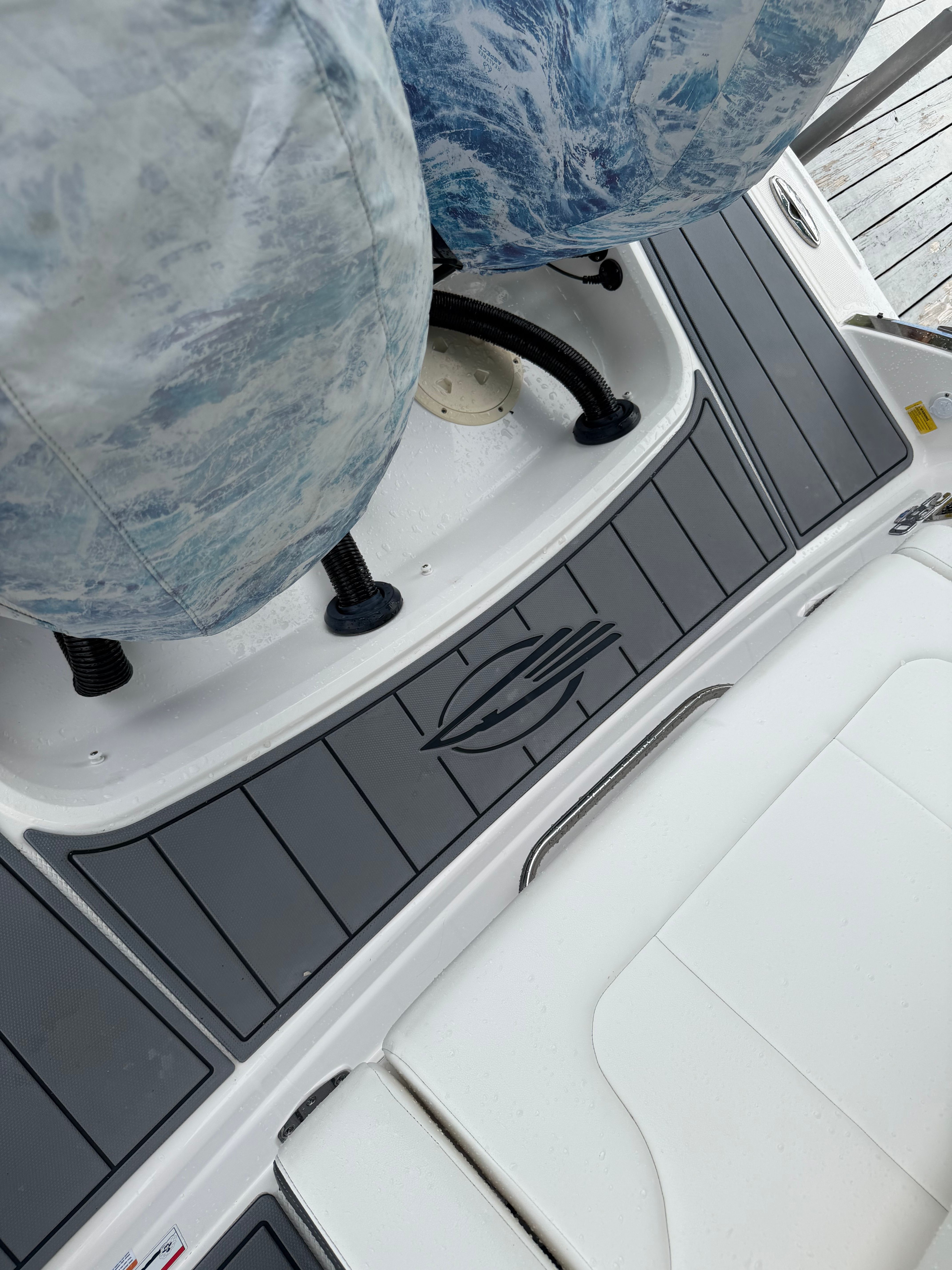 Close-up of a Chaparral 280 OSX boat deck with gray and white seating.