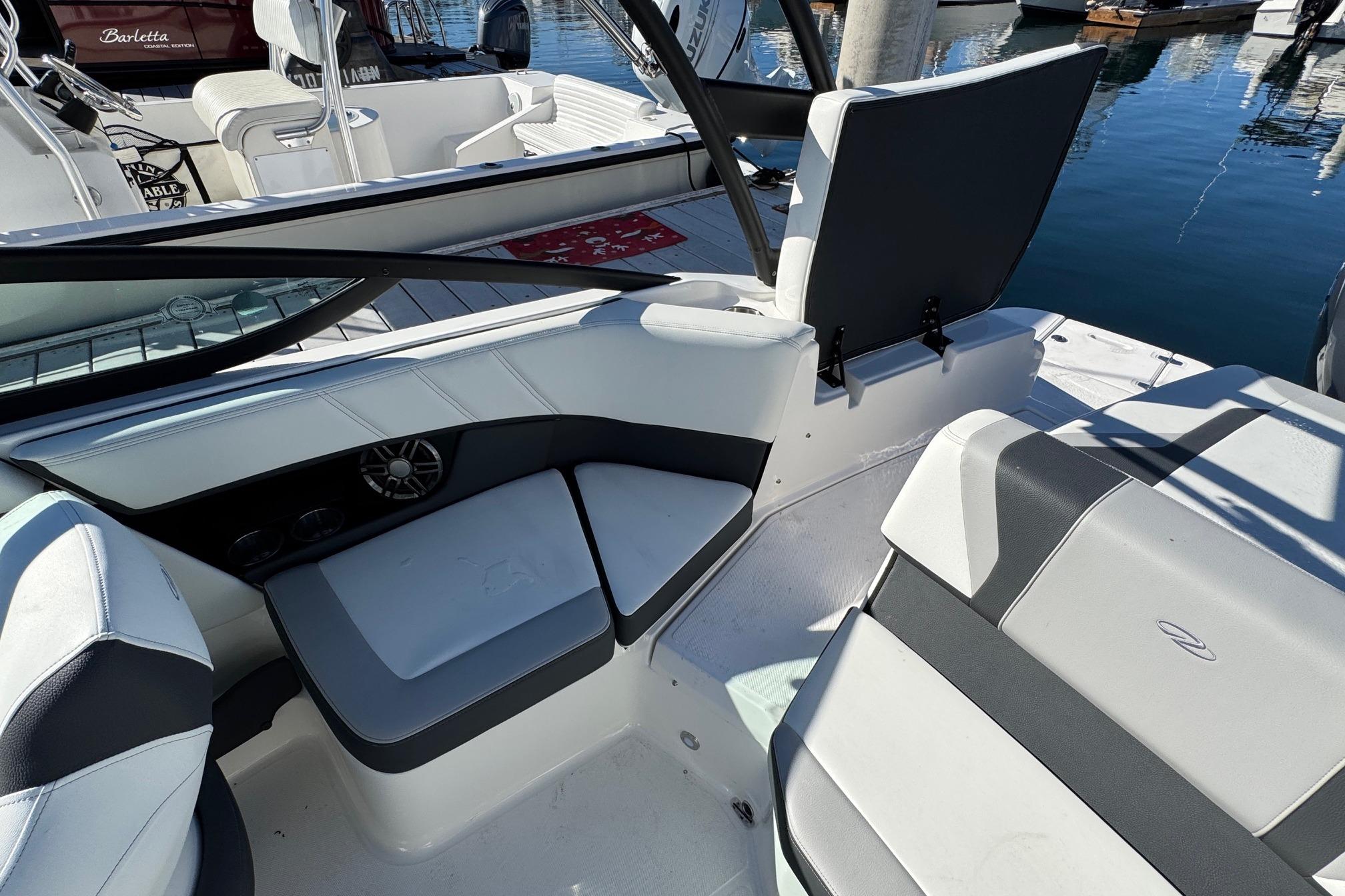 2026 Regal 21 OBX boat interior with white and gray seating at a marina.