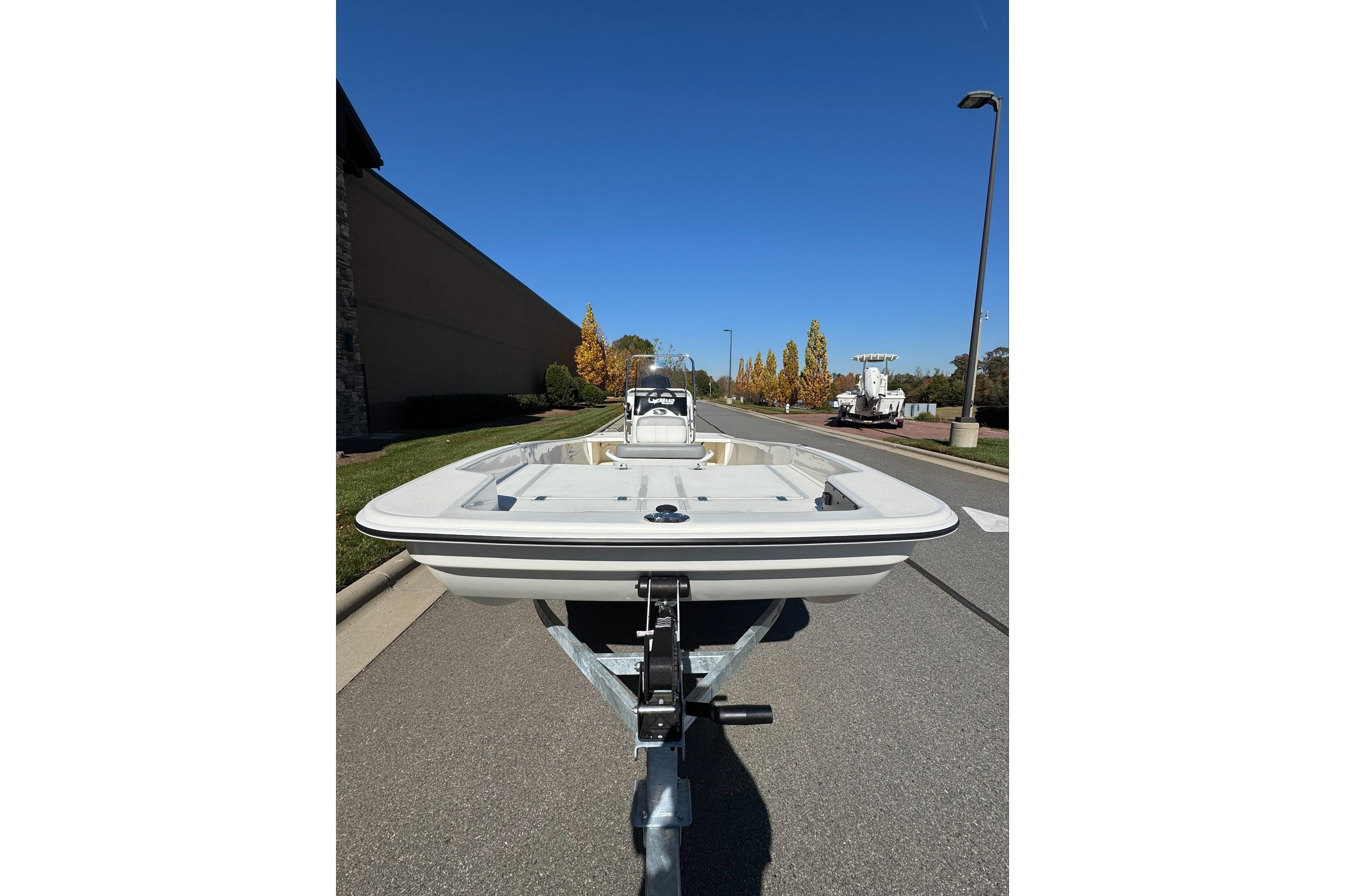 2026 Mako Pro Skiff 17 CC boat on trailer, parked on a sunny street.
