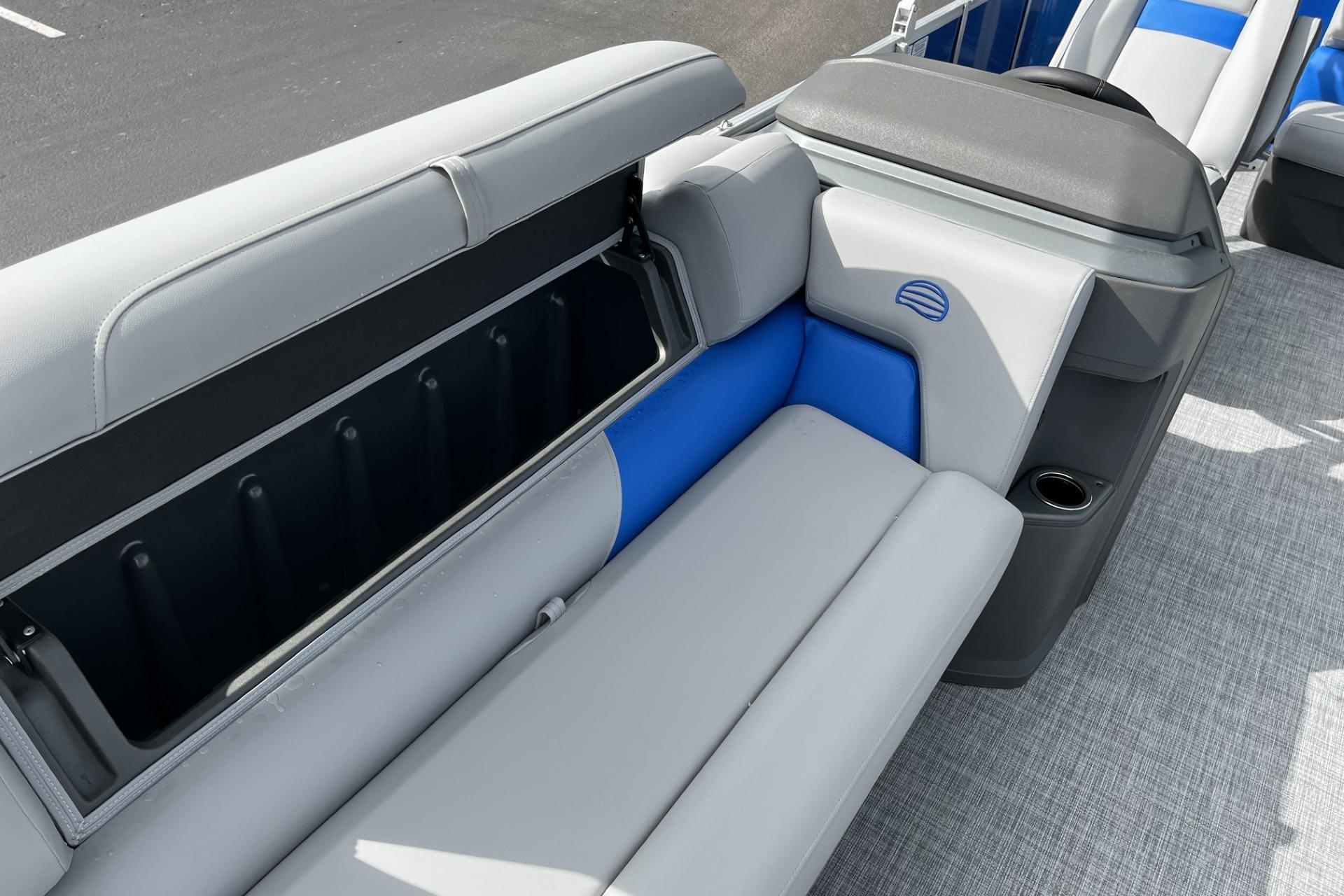 2026 Sun Tracker Party Barge 20 DLX interior seating with storage compartment.