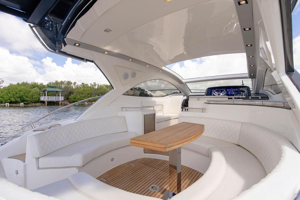 Luxurious 2022 Schaefer 400 Sport yacht interior with elegant seating and wooden table.