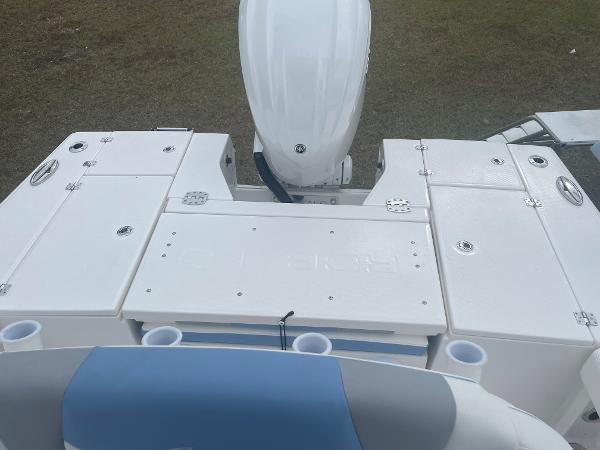 2026 Robalo 246 Cayman boat deck with storage compartments and motor.