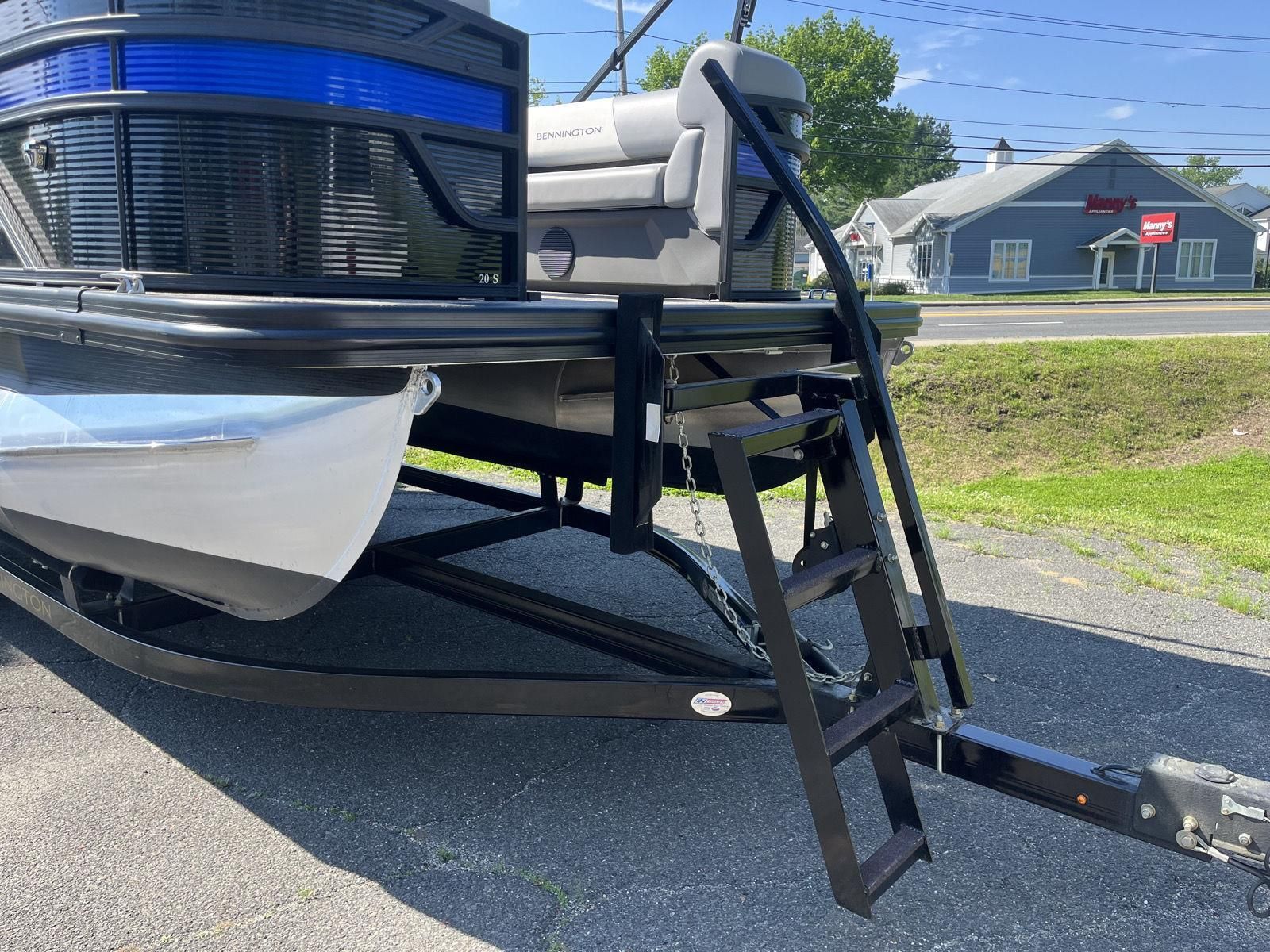 A 2025 Bennington S20 pontoon boat on a trailer, featuring a side ladder.