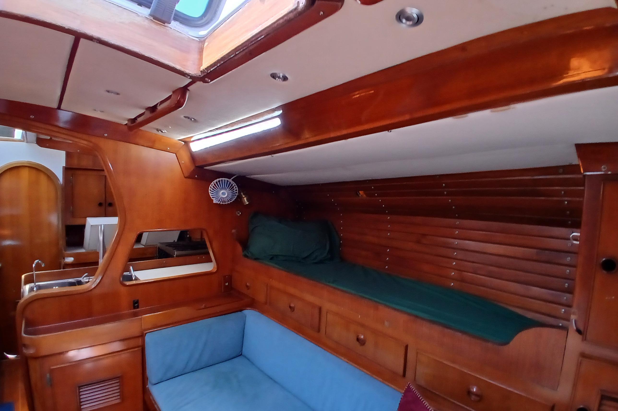 Interior of 1981 SKYE 51 yacht with wooden finish and cozy seating area.