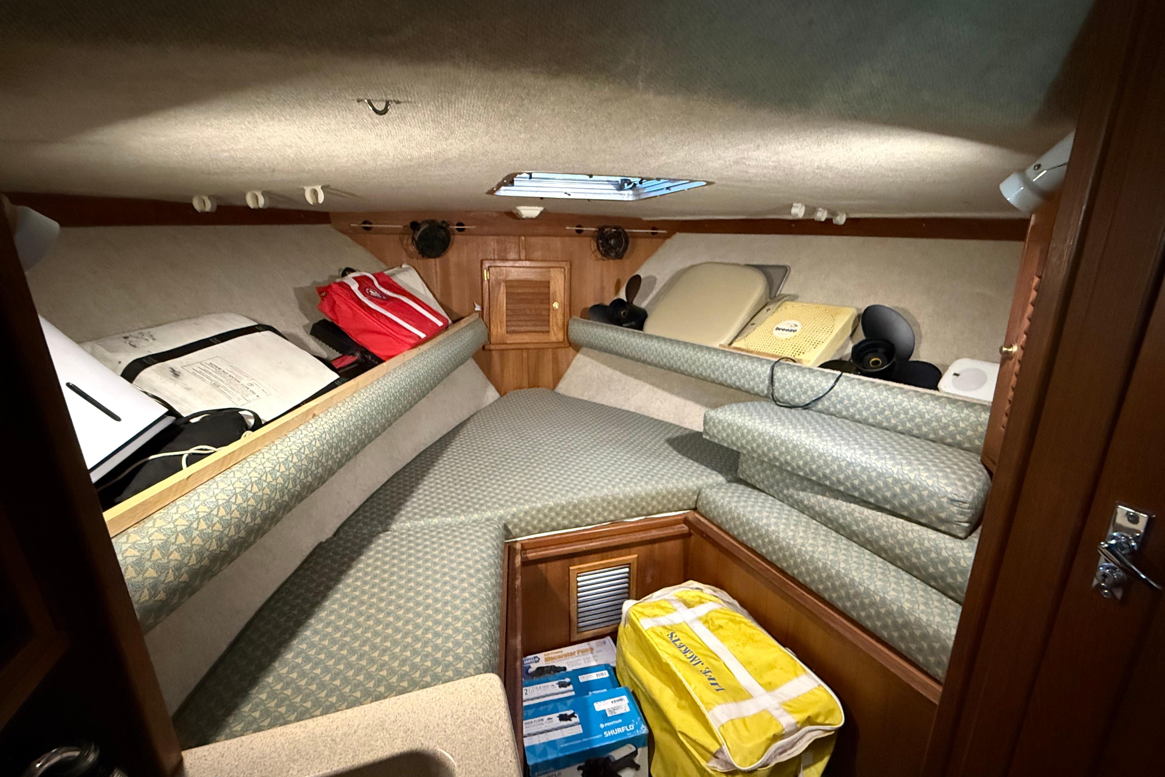 2002 Albemarle 265 Express Fisherman cabin interior with cushions and storage.