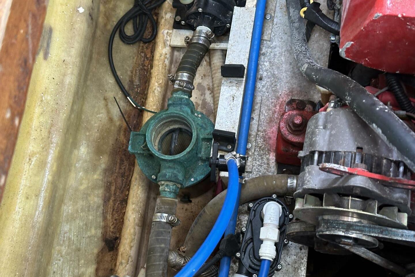 Engine compartment of a 1986 Pan-Oceanic 46 boat, showing mechanical components and hoses.