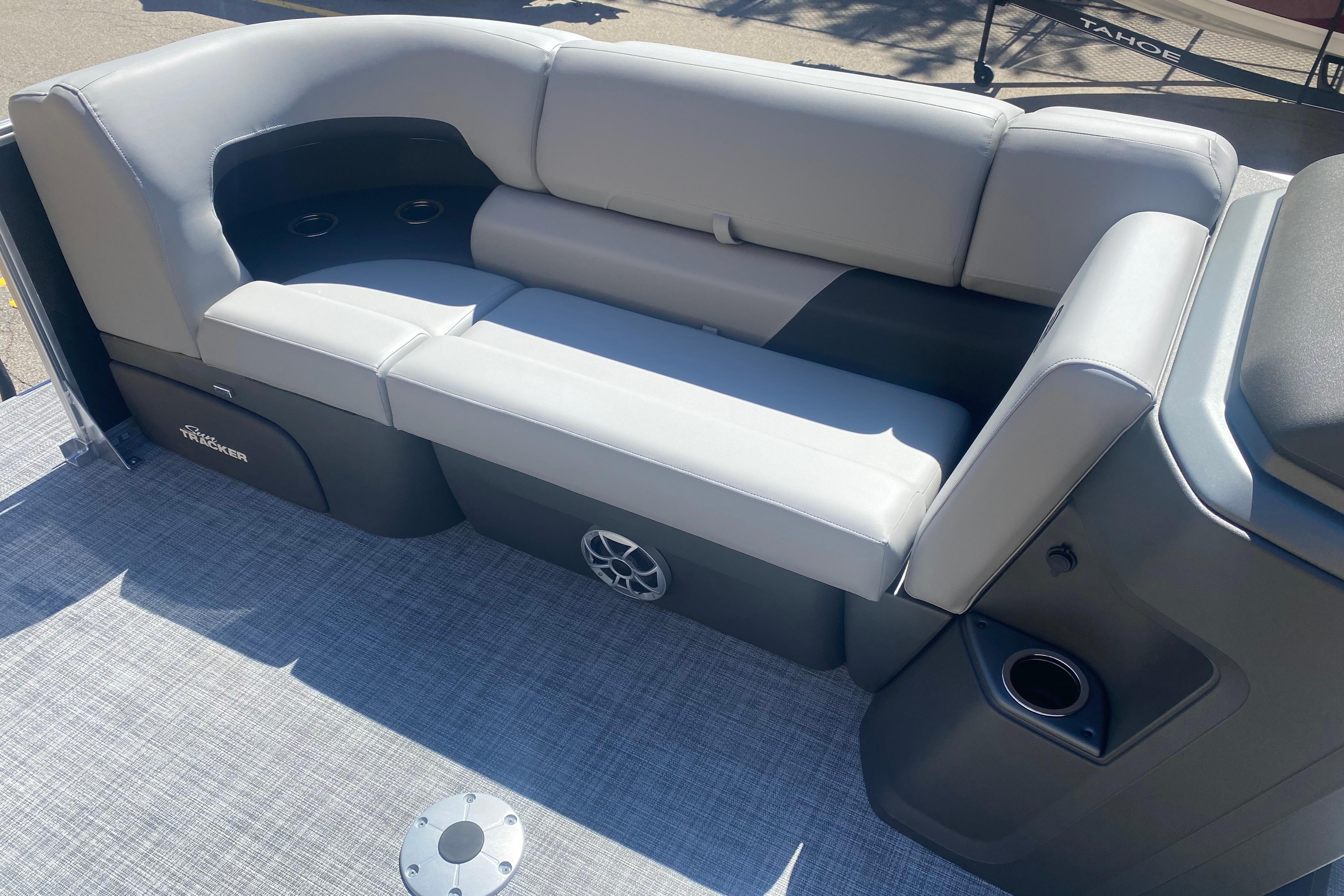 2026 Sun Tracker Party Barge 22 RF DLX interior with gray seating and cup holders.