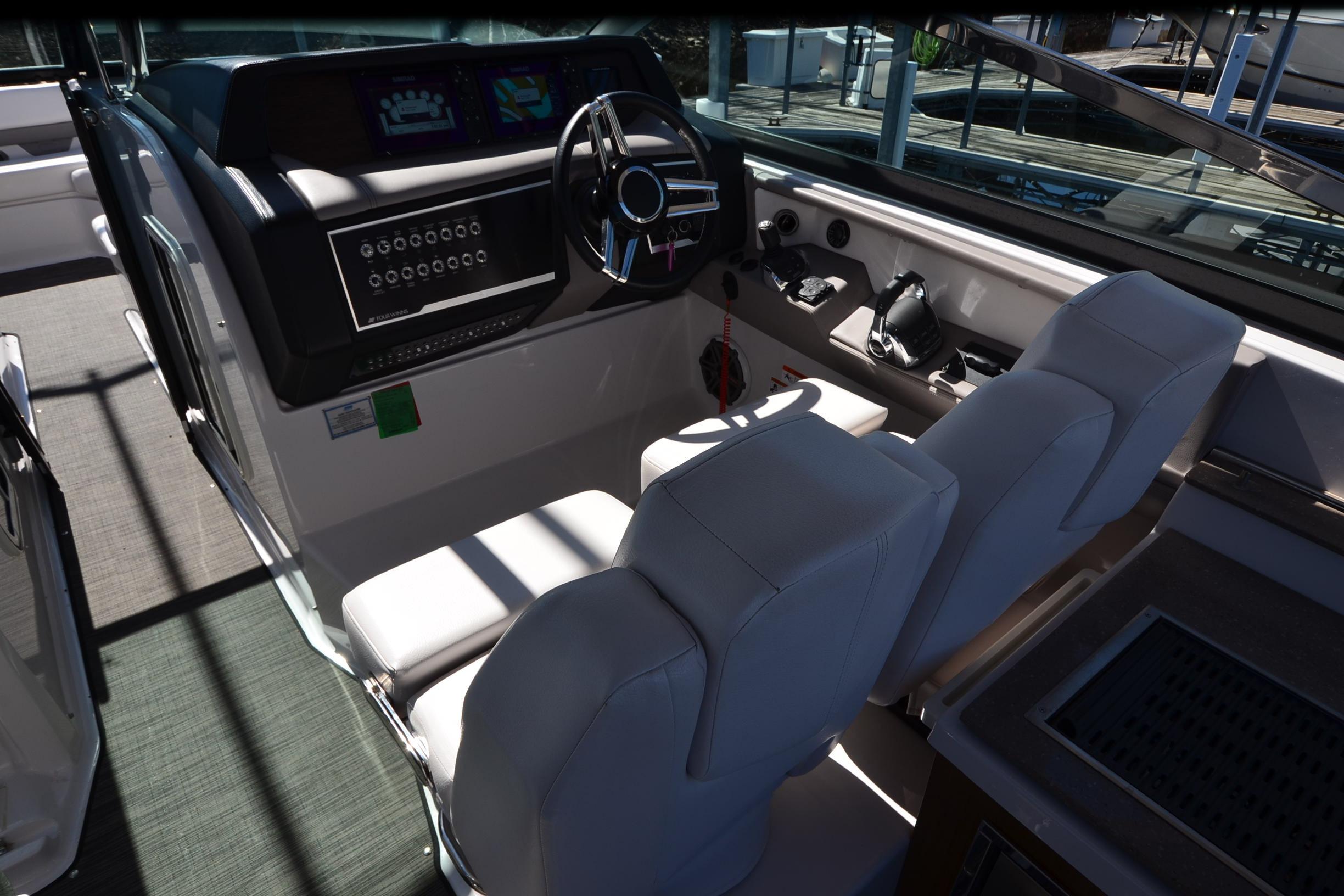 2018 Four Winns H350 boat cockpit with dual seats and modern dashboard controls.