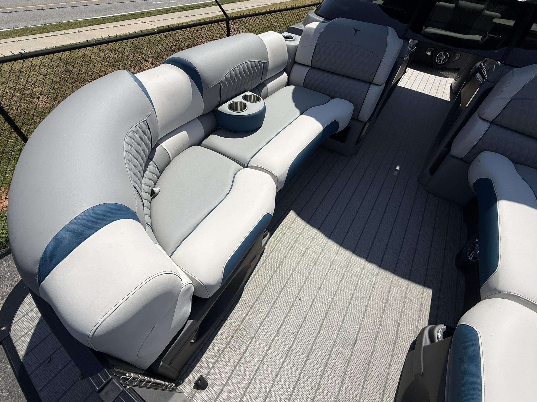 2025 Tahoe Pontoon Grand Tahoe Elite Windshield interior with luxurious seating and cup holders.