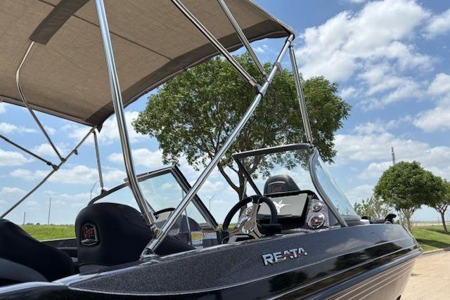 2026 Ranger 212LS boat with canopy, steering wheel, and clear sky background.