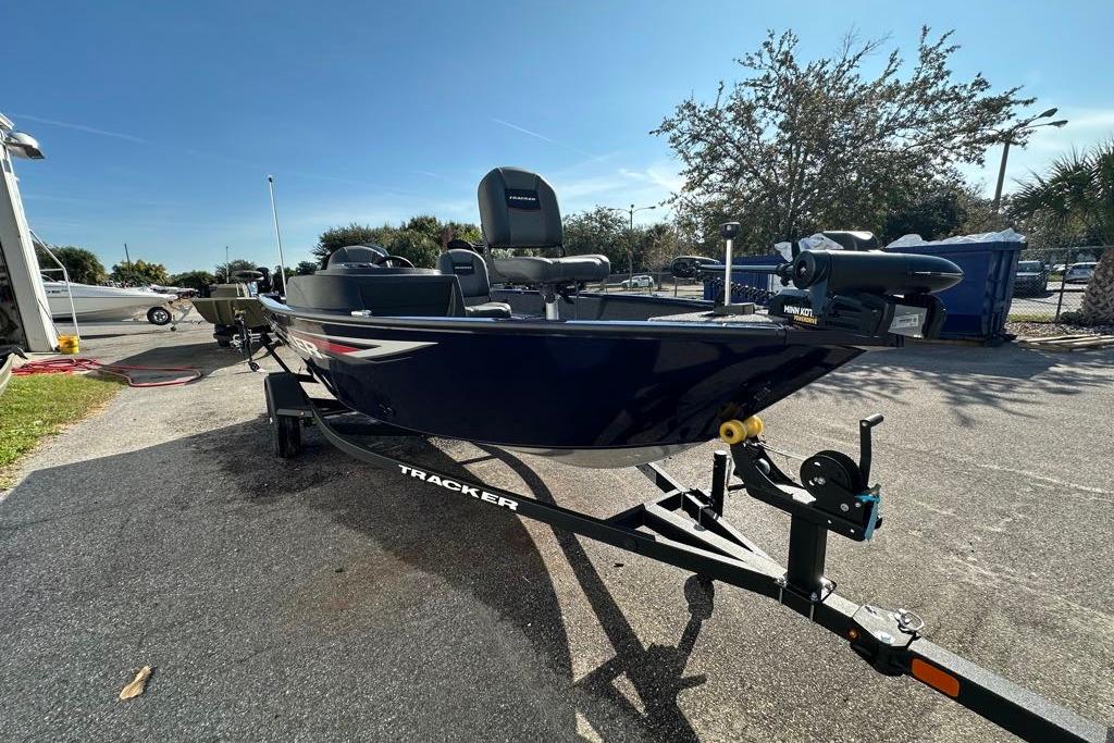 2026 Tracker Pro Guide V-16 SC boat on trailer, parked outdoors.