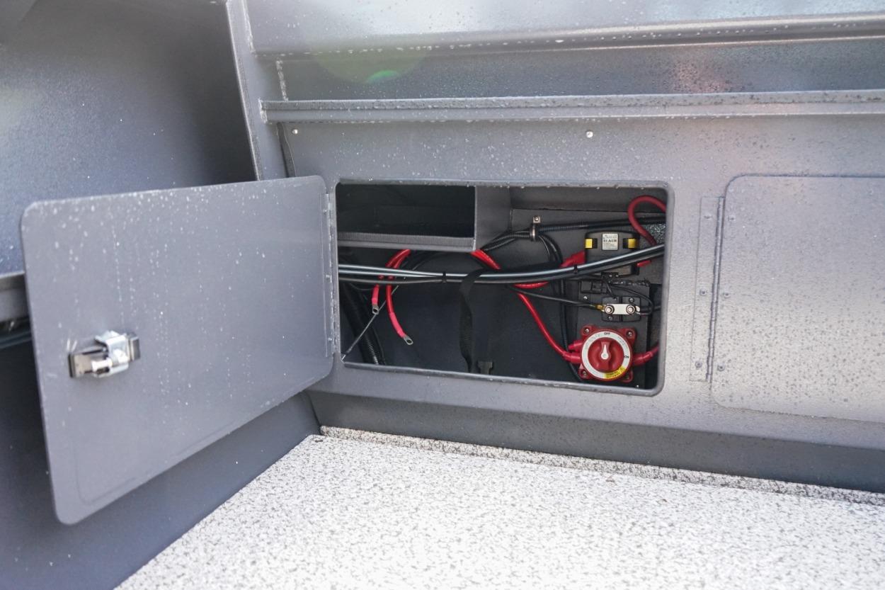 2026 Alumaweld X202 Stryker boat compartment with wiring and battery switch.