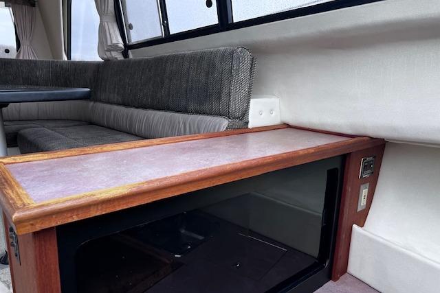 Interior of 1996 Bayliner 3388 Command Bridge Motoryacht with seating and wooden cabinetry.