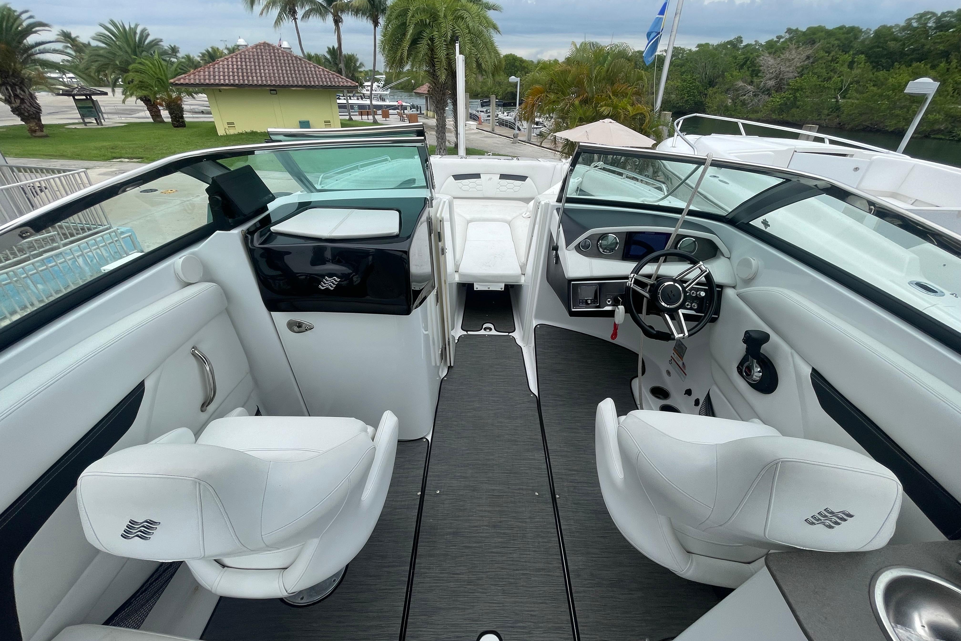 2022 Four Winns HD8 OB boat interior with white seating and modern dashboard.