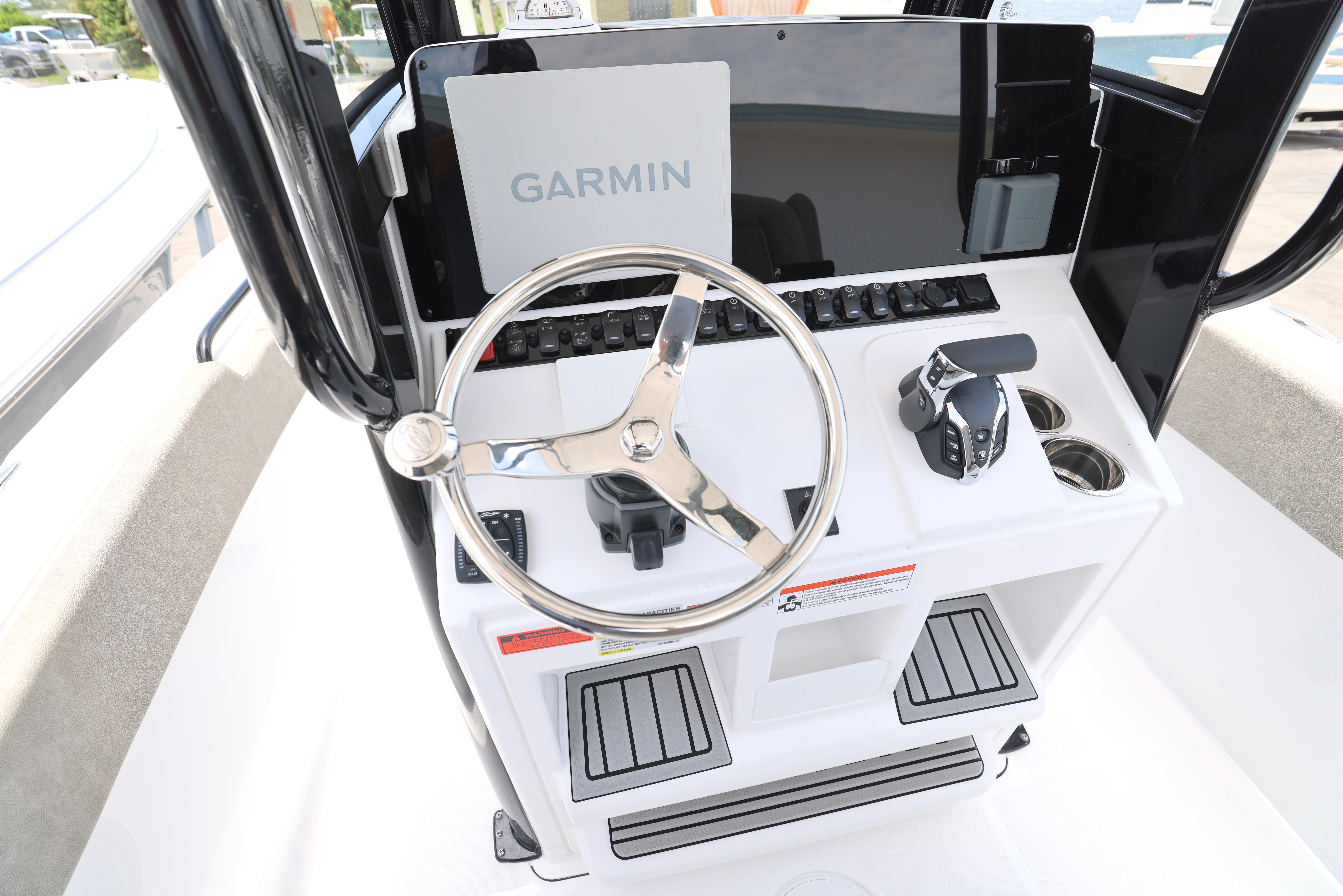 2026 Sea Hunt Ultra 245 SE boat console with Garmin display and steering wheel.