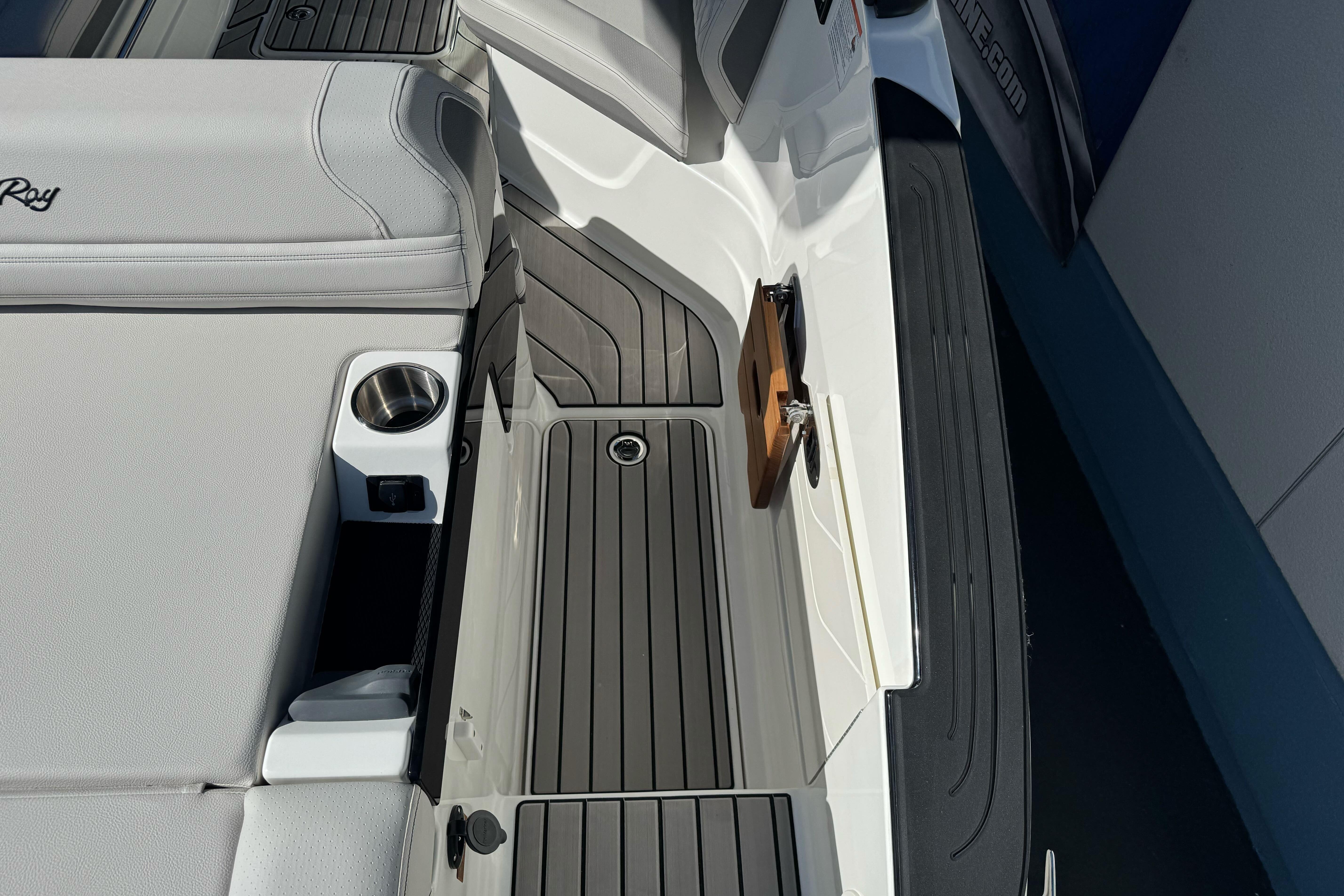 Interior view of 2026 Sea Ray SLX 260 boat with sleek seating and cup holder.