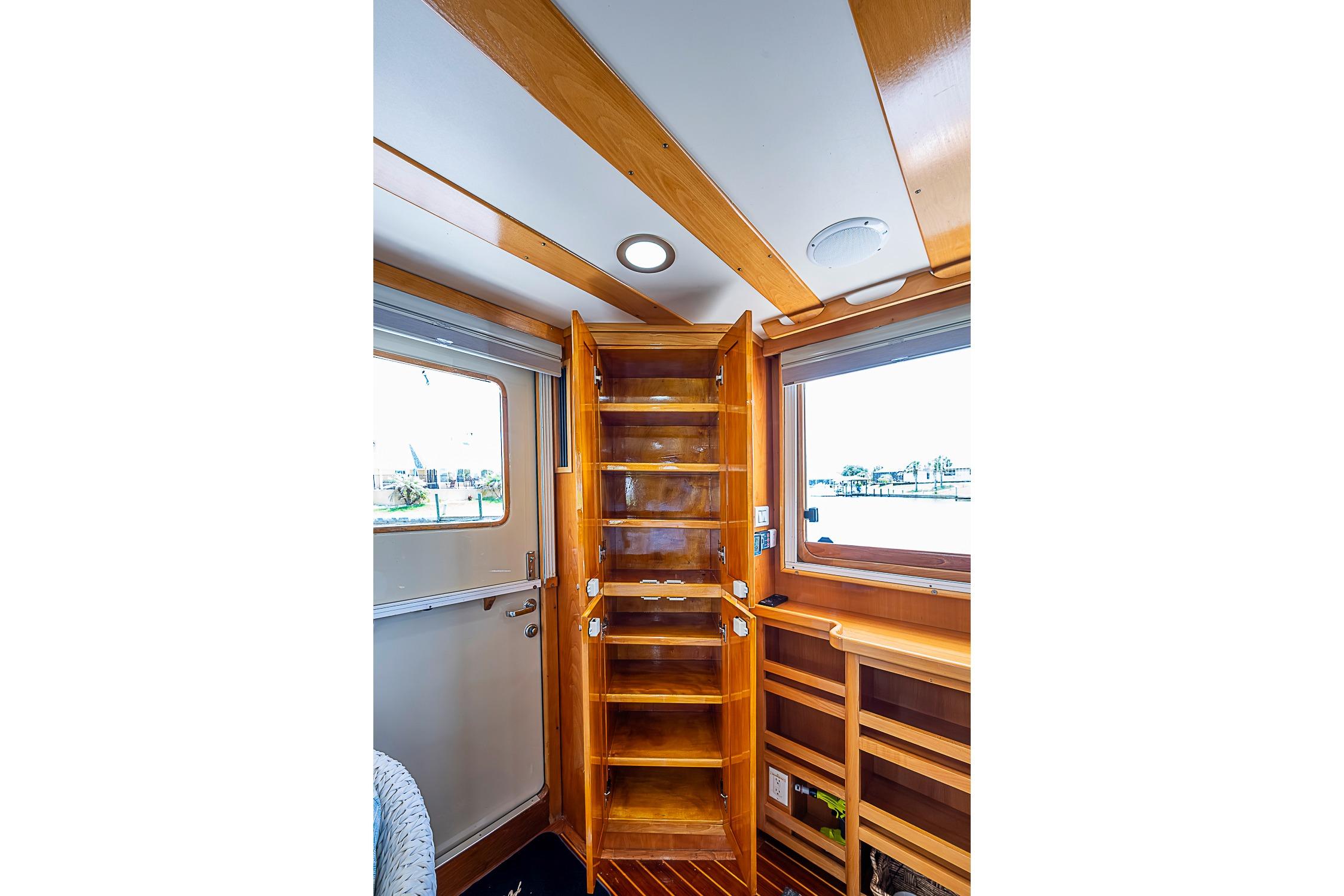 Interior of 2003 Magna Marine Nova Scotia 47, featuring wooden cabinetry and windows.