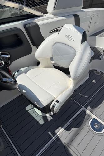 2023 Chaparral 267 SSX boat interior with luxurious white captain's chair and sleek design.