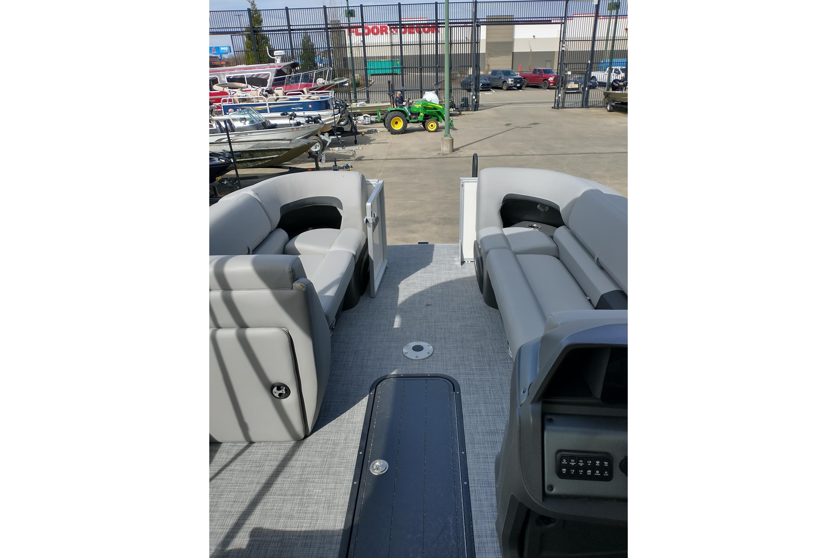 2026 Sun Tracker Party Barge 22 XP3 with gray seating, displayed outdoors.