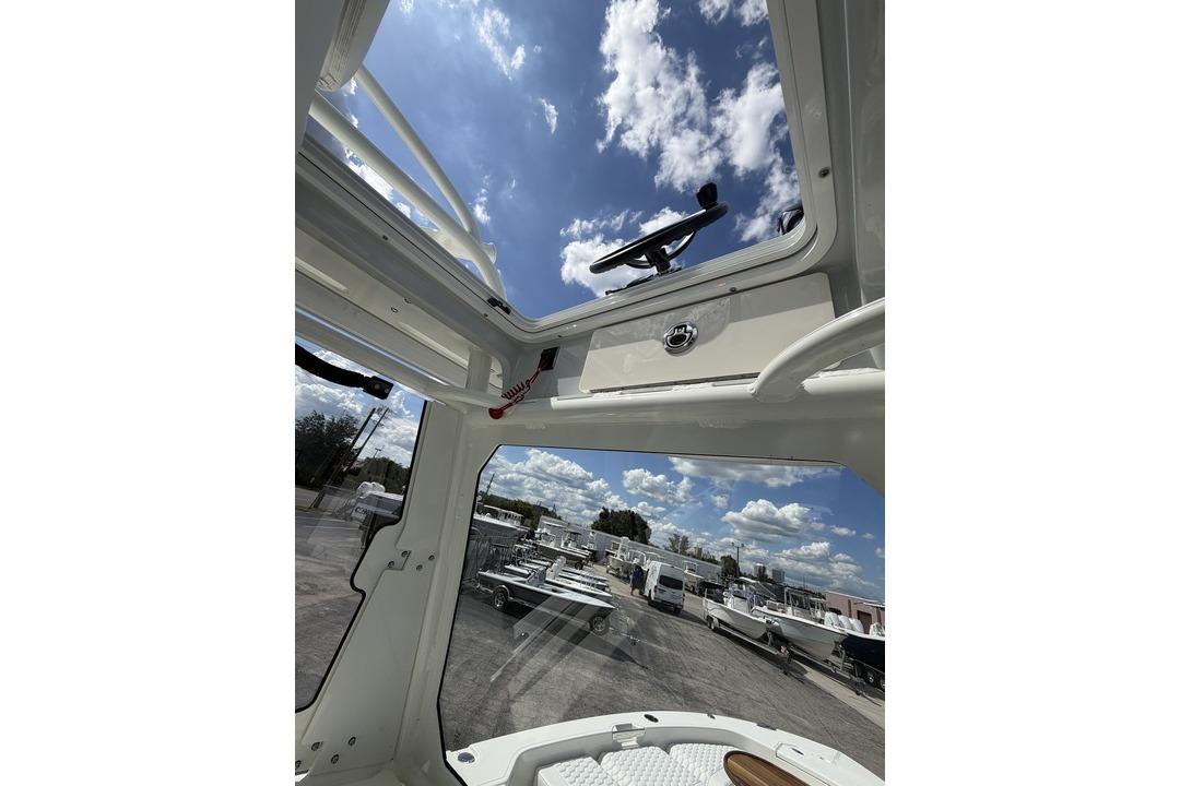 Interior view of 2026 Pathfinder 2800 Hybrid boat under a clear blue sky.