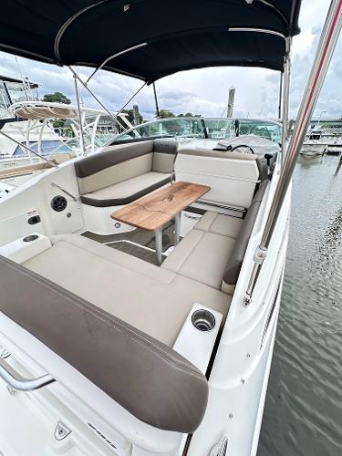 2015 Sea Ray 260 Sundancer boat with spacious seating and wooden table on deck.