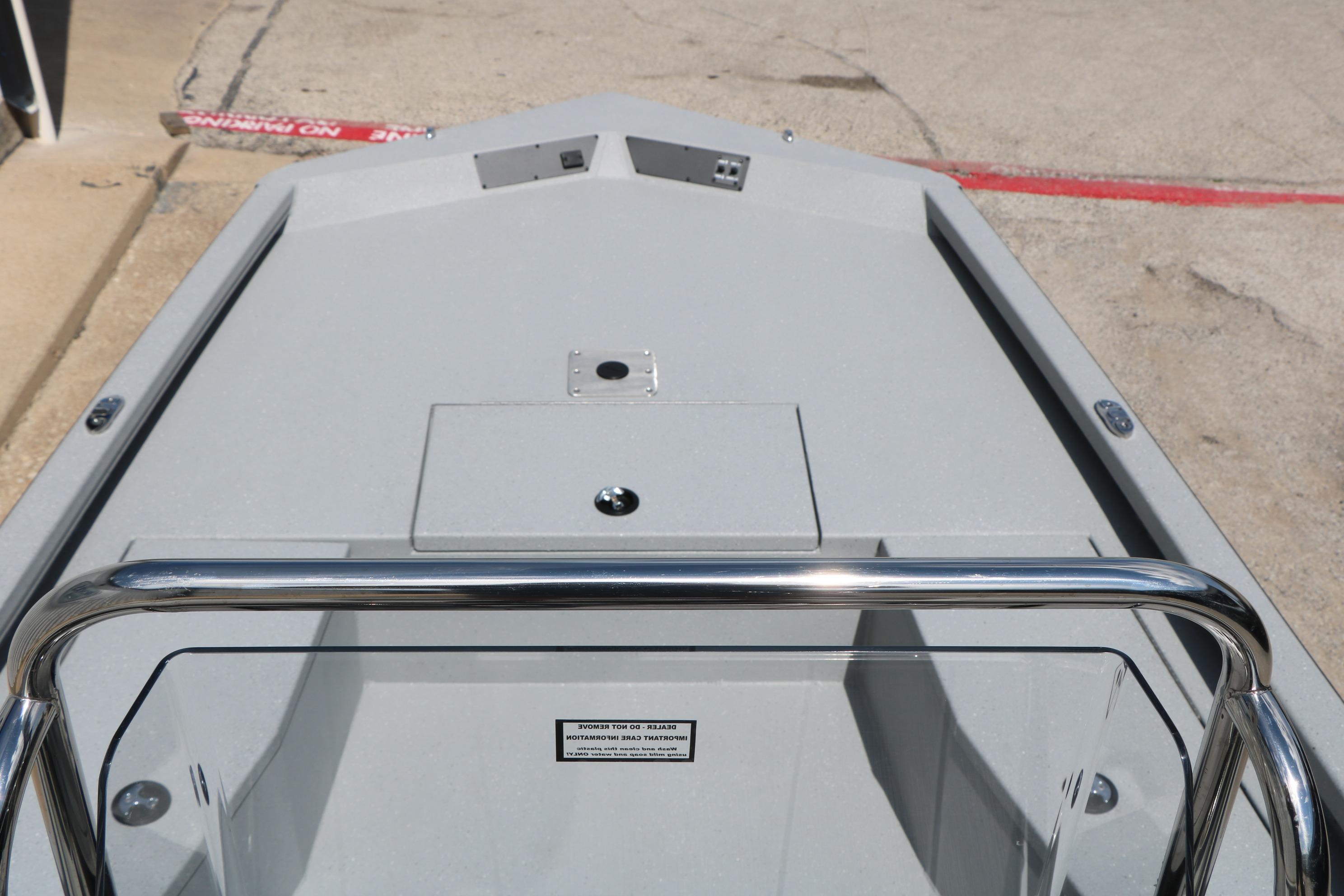 2026 Vexus Defender 201 boat deck with stainless steel railing and storage compartment.