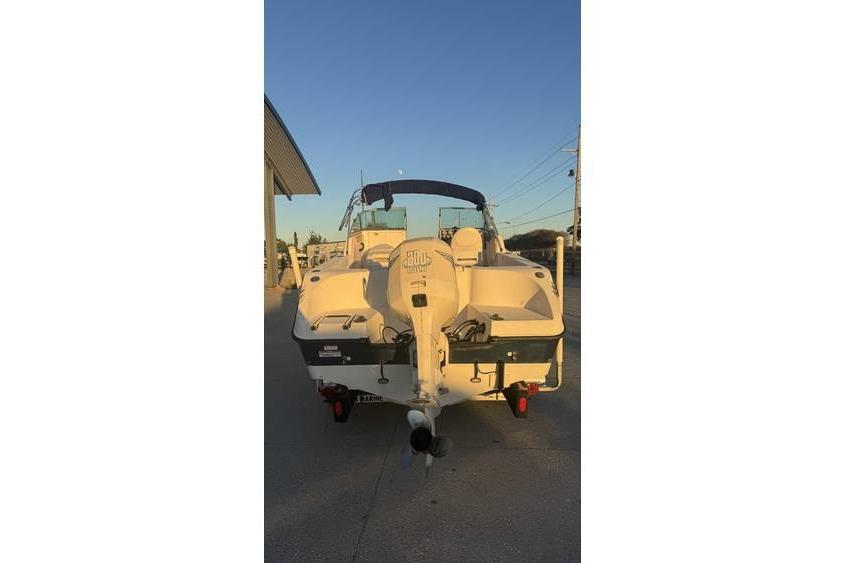 2006 Seaswirl Striper 2101 Dual Console OB boat, rear view at sunset.