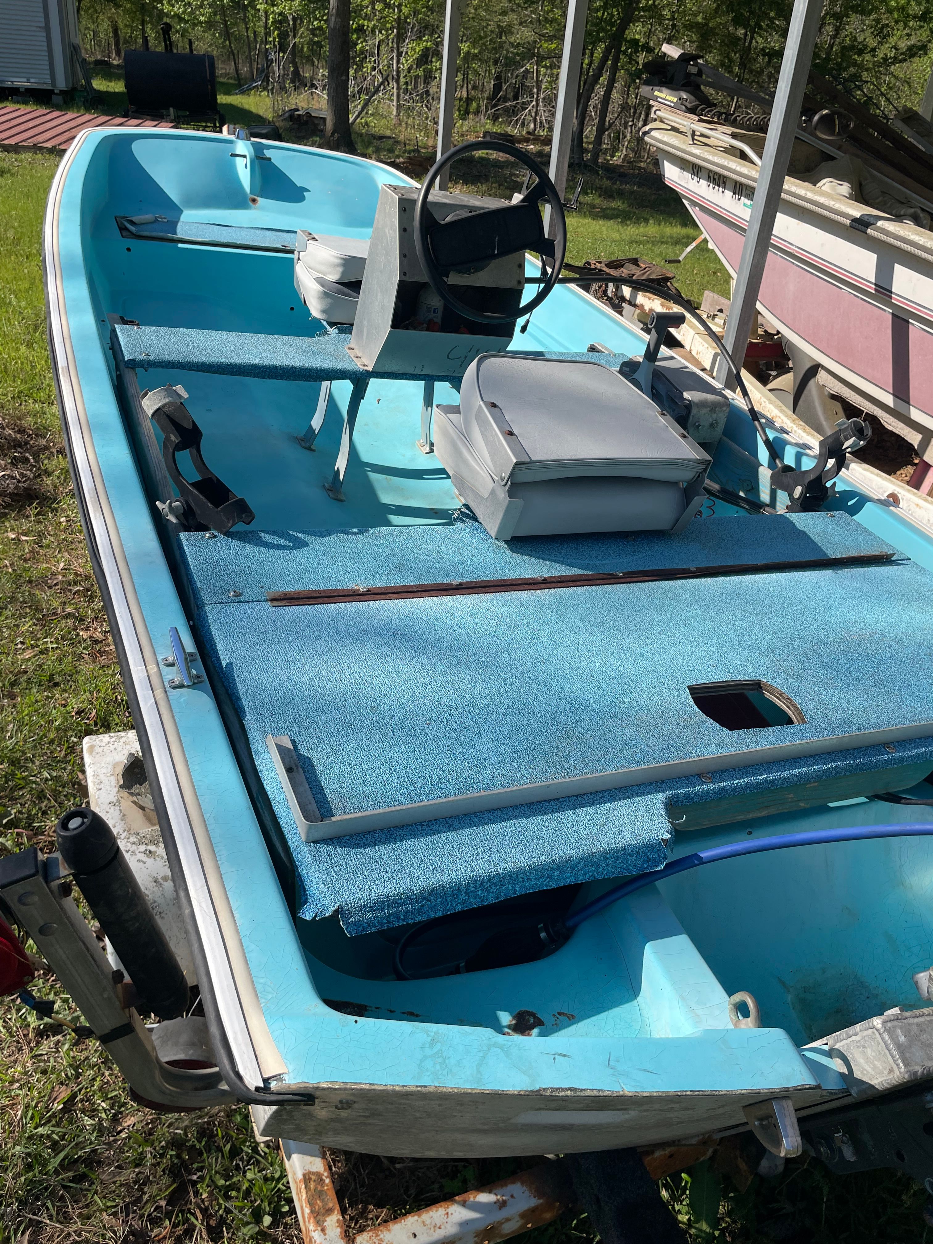 1964 Boston Whaler 13’ 6” boat with blue interior.