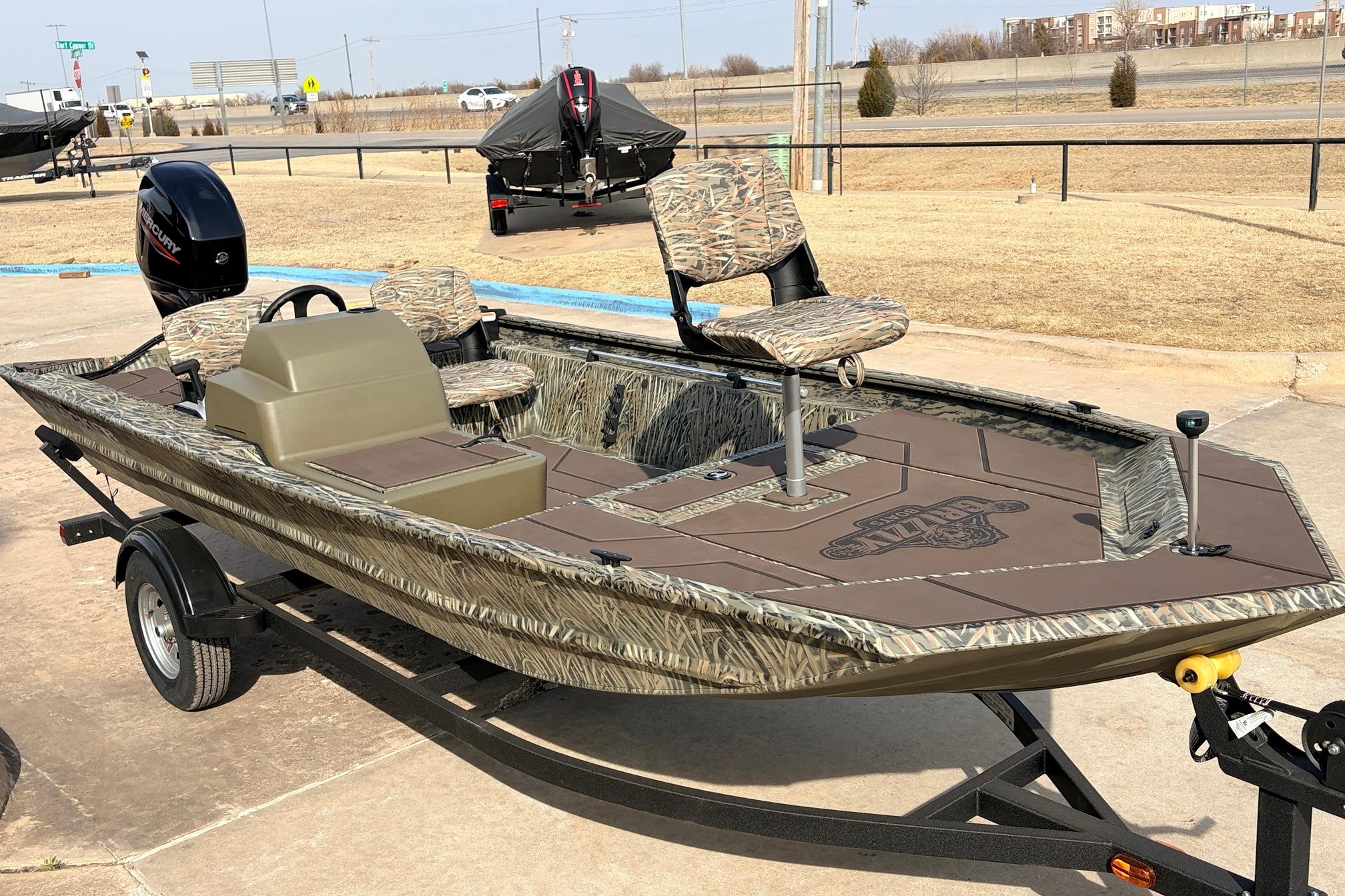 2026 Tracker Grizzly 1754 SC boat on trailer, camo design, outdoor setting.