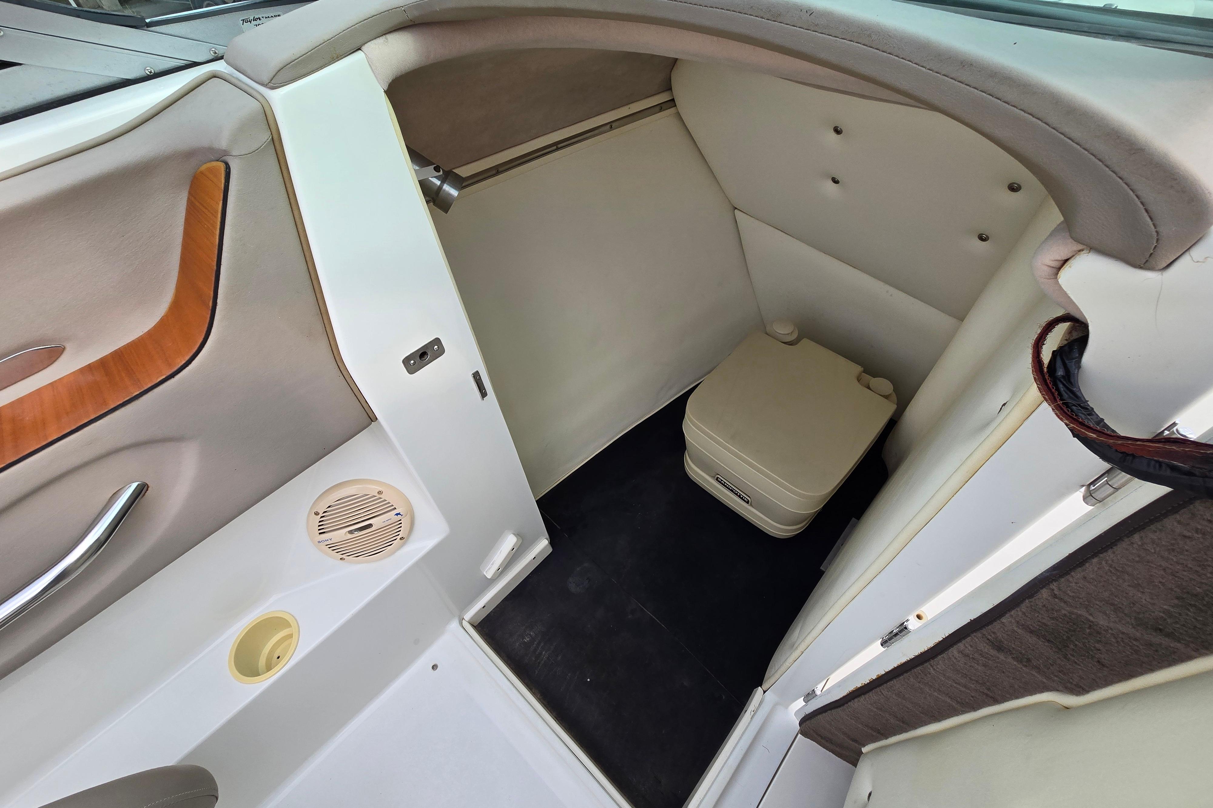 Interior of a 2000 Cobalt 246 boat featuring a compact restroom area.
