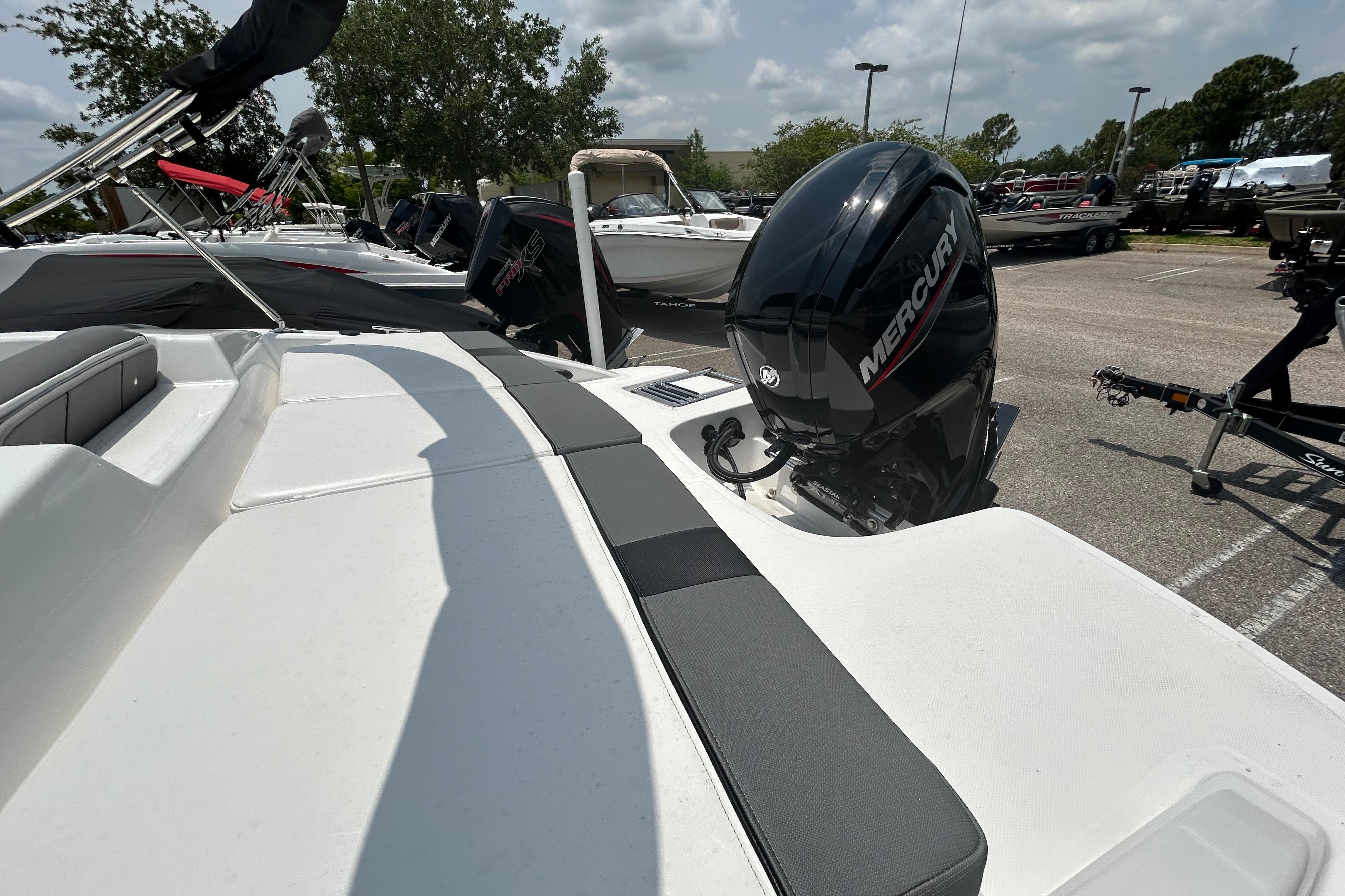 2026 Tahoe T18 boat with Mercury outboard motor in a parking lot.