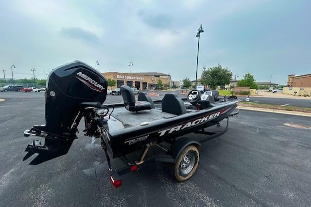 2026 Tracker Pro Team 175 boat with Mercury engine in parking lot.