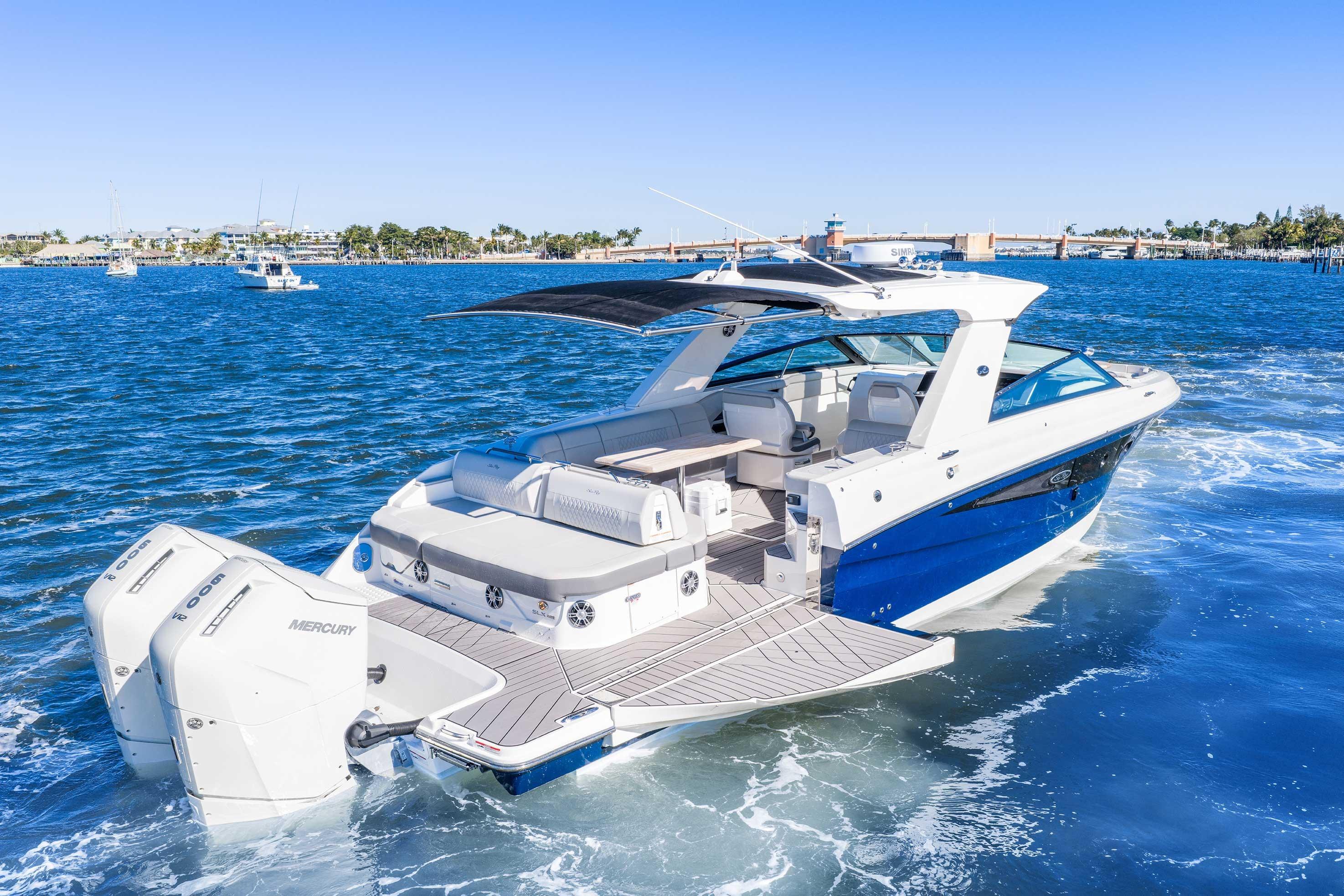 2023 Sea Ray SLX 400 Outboard cruising on blue waters, showcasing luxury and performance.