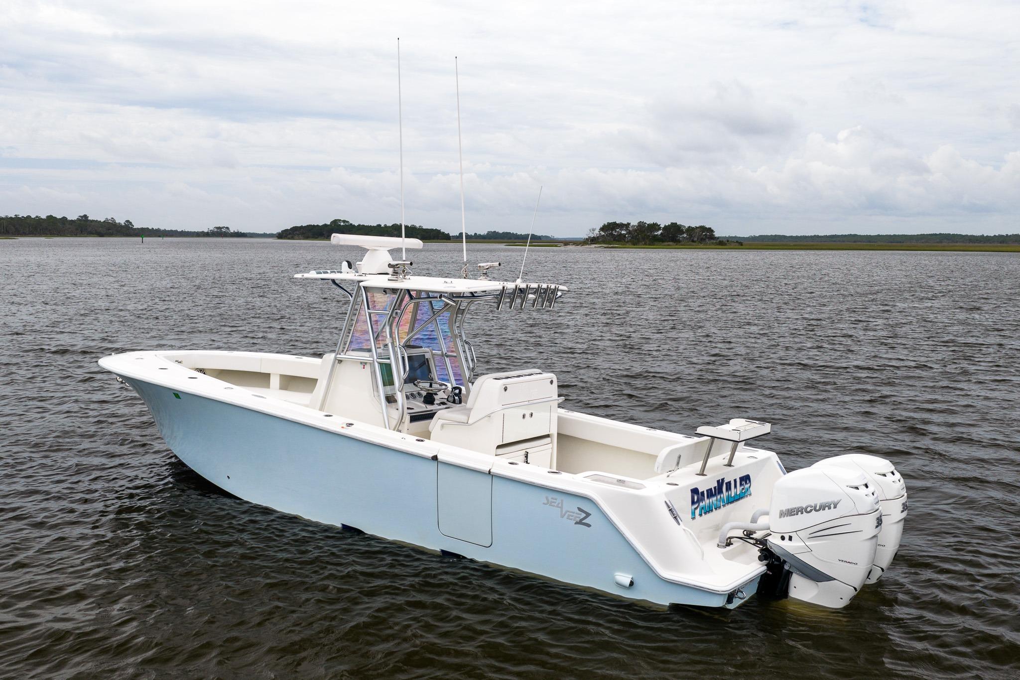 2019 SeaVee 322Z boat on calm water, featuring twin Mercury engines.