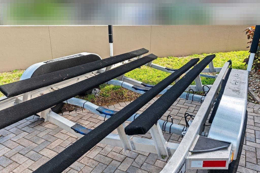 Boat trailer for Everglades 243 Center Console 2023 on paved surface.