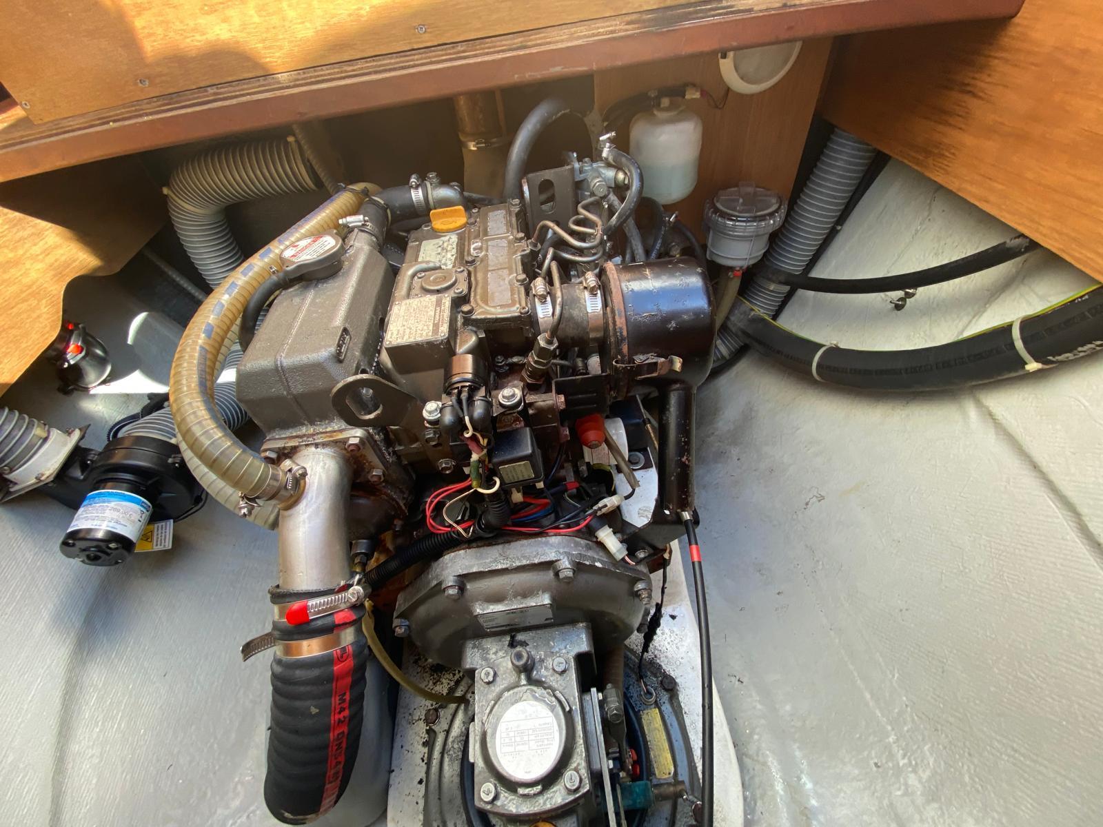 Engine compartment of a 2014 Lagoon 380 S2 catamaran, showcasing mechanical components and hoses.
