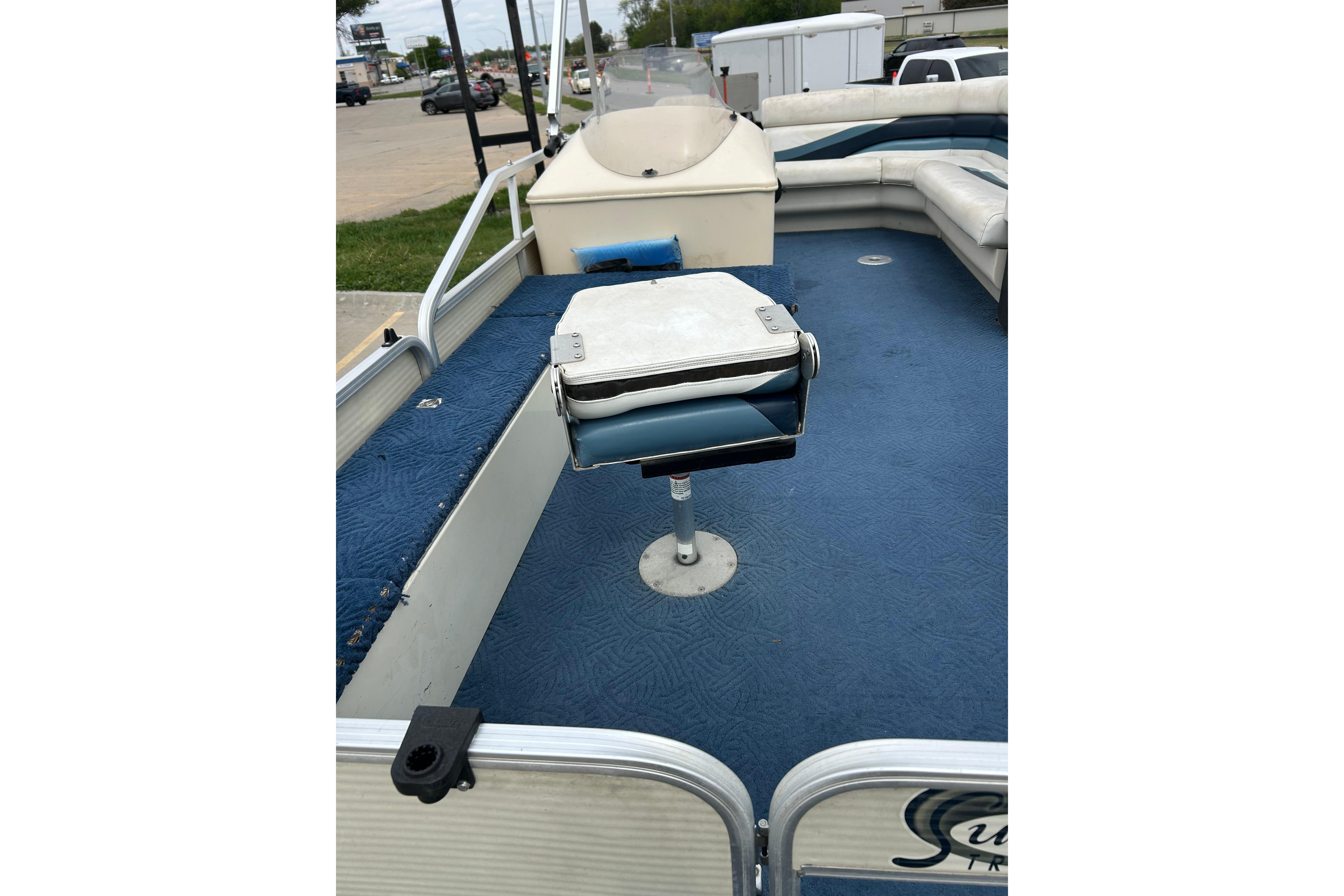 2002 Lowe Trinidad 200 pontoon boat interior with blue carpet and seating.
