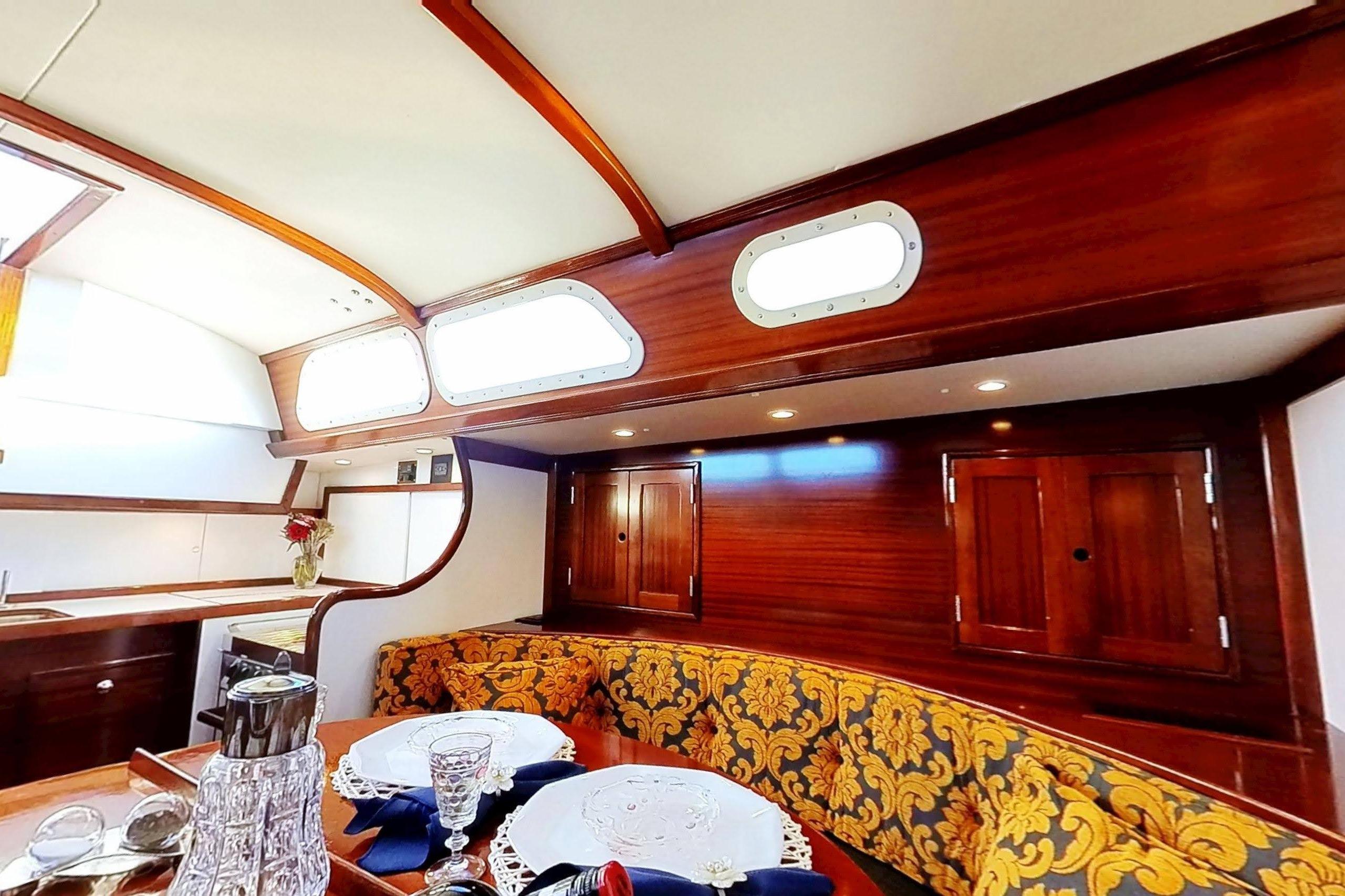 Interior of a 1970 Hinckley Bermuda 40 yacht with elegant wood finish and dining area.