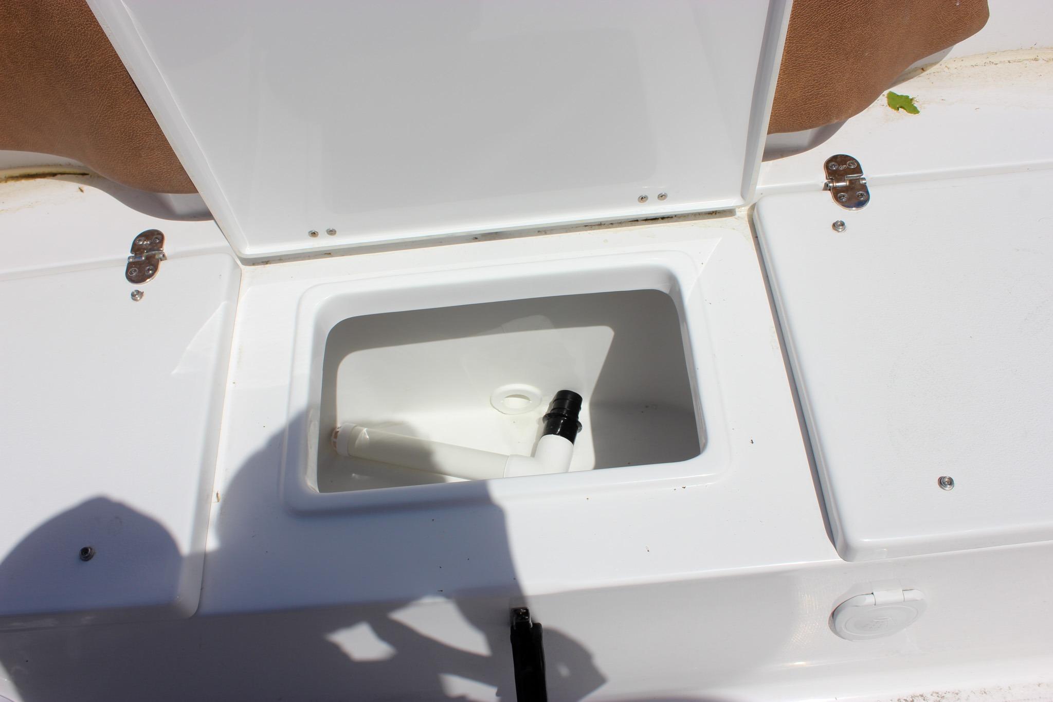 Open storage compartment on a 2027 Sea Hunt Ultra 234 boat deck.