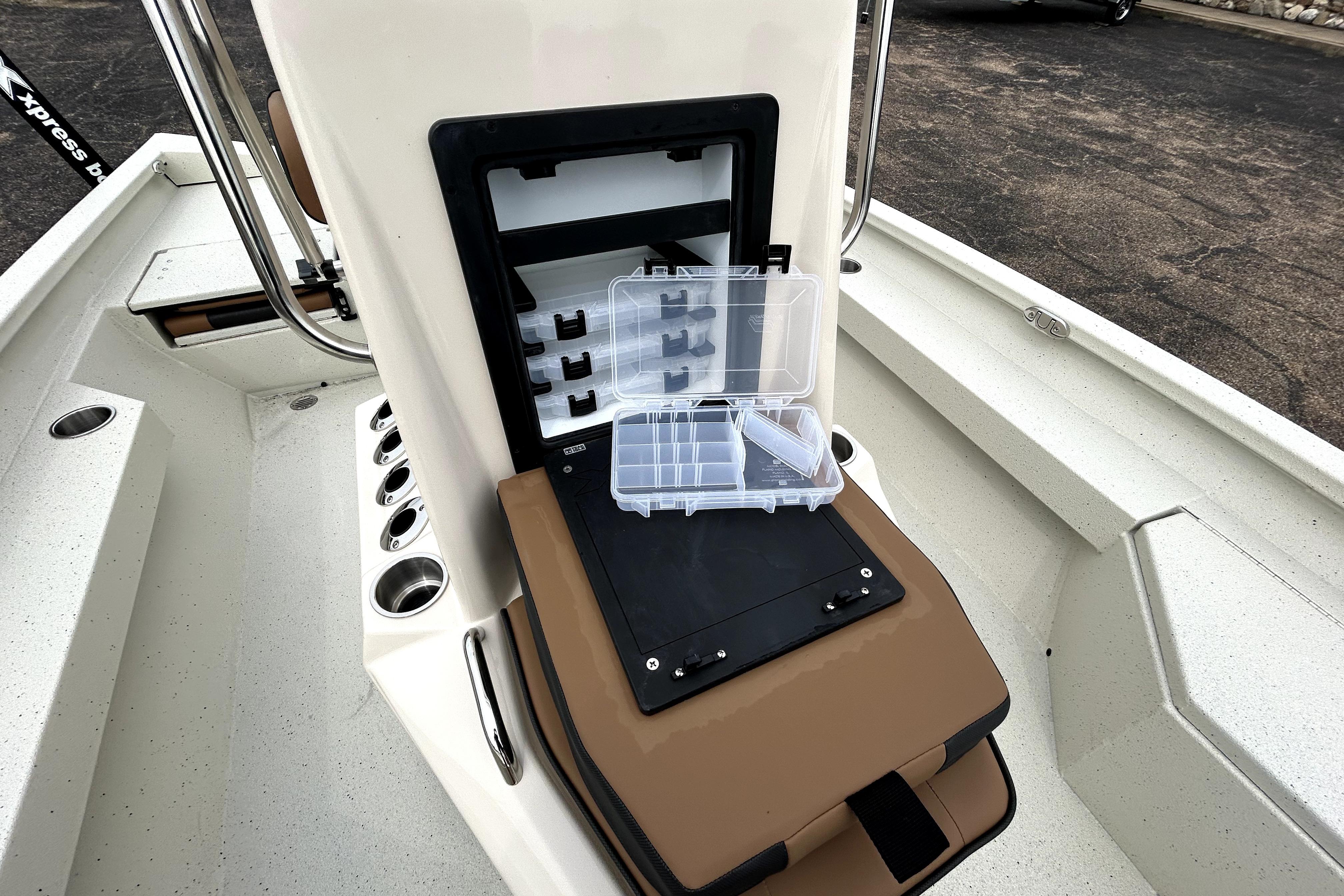 2026 Xpress H20B Bay boat interior with open storage compartment and tackle box.