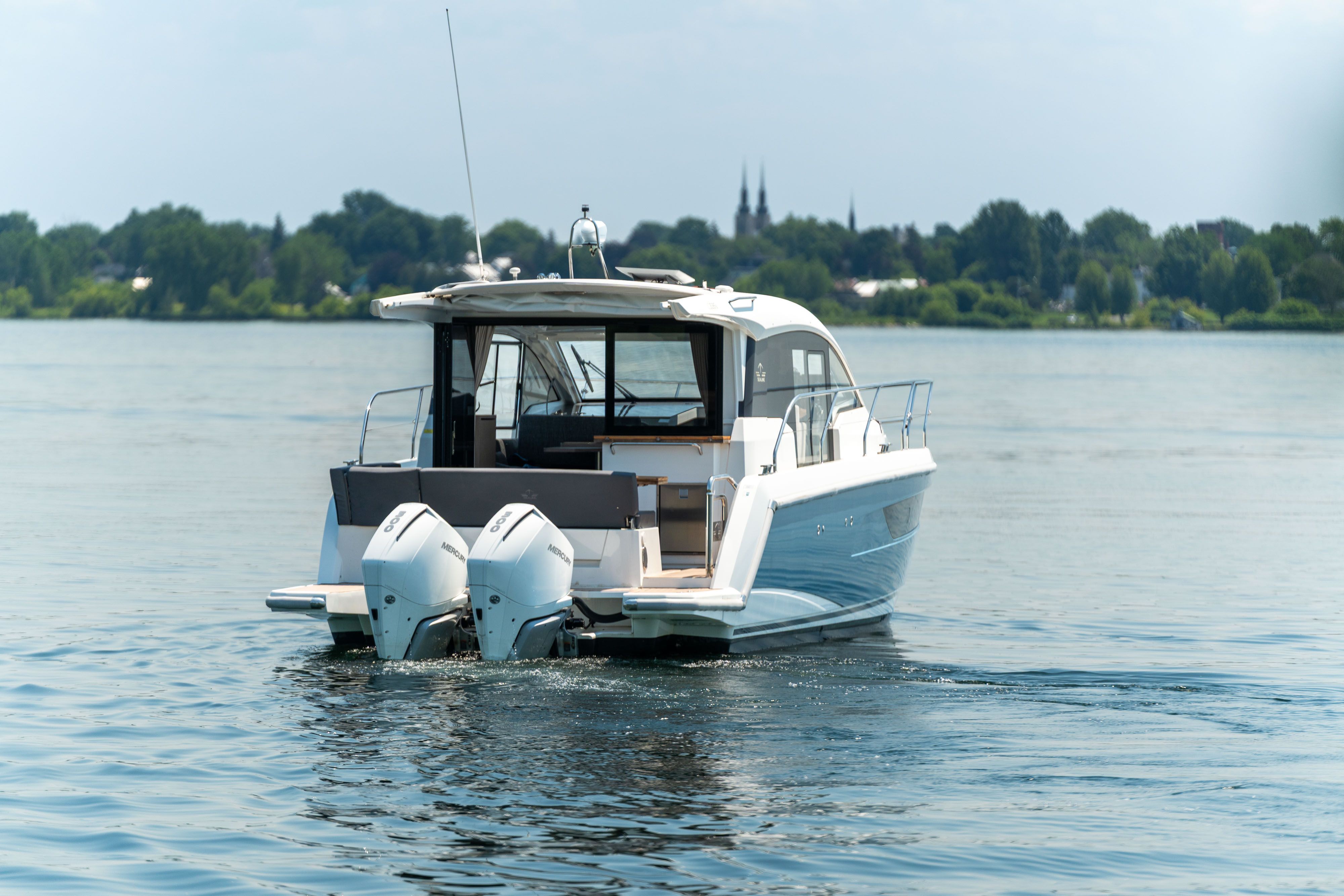Sealine C335V 2023 on calm water with twin outboard engines.
