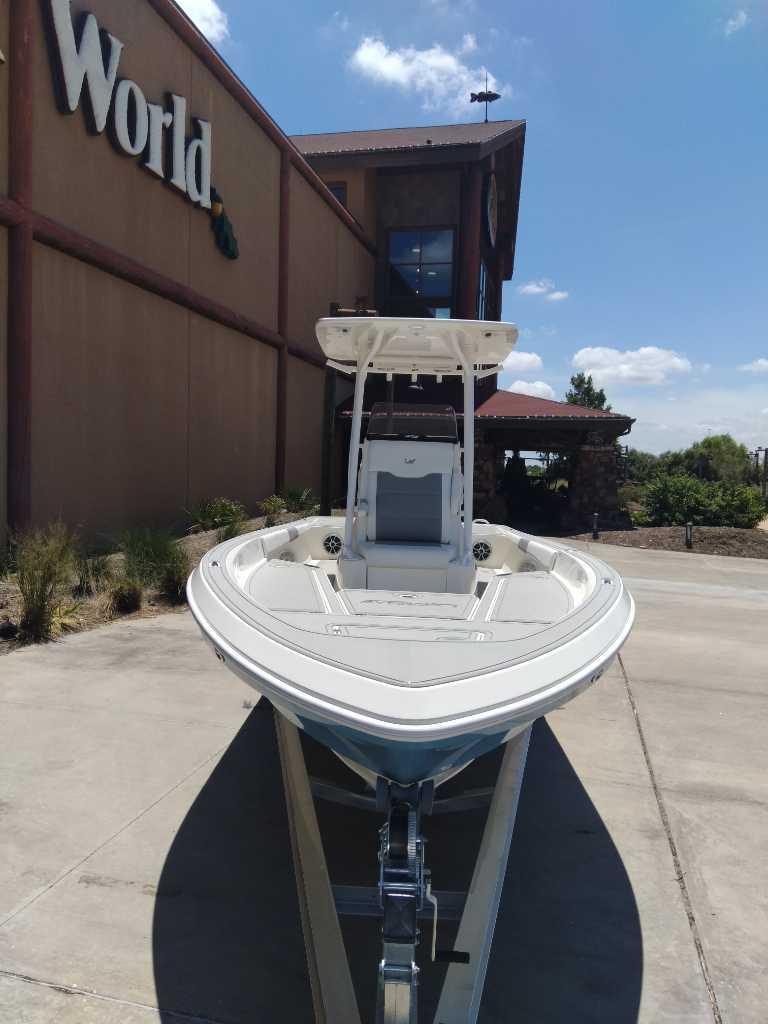 2025 Mako 24 APEX boat displayed outside a store under a clear blue sky.