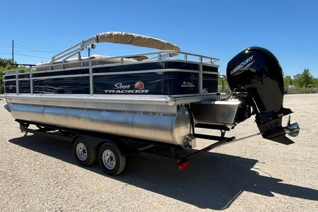 2025 Sun Tracker Fishin' Barge 22 DLX pontoon boat with Mercury outboard motor on trailer.
