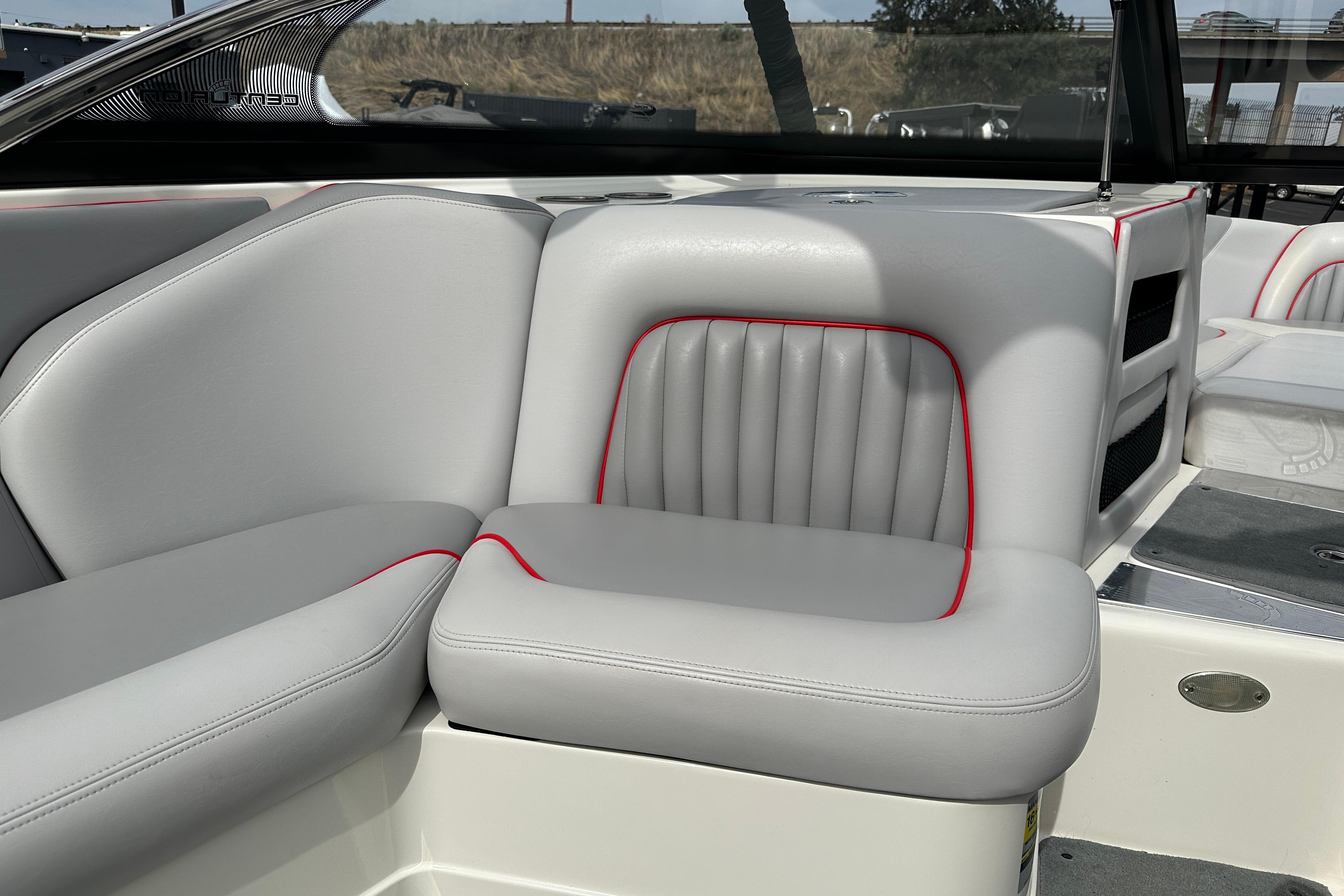 2008 Centurion Enzo SV240 boat interior with gray and red-trimmed seating.