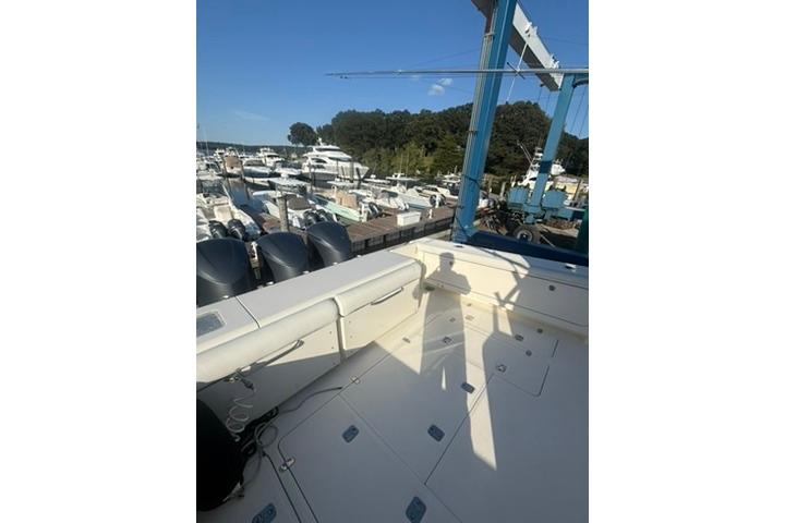 2010 Pursuit OS 375 Offshore boat docked at marina with multiple yachts.